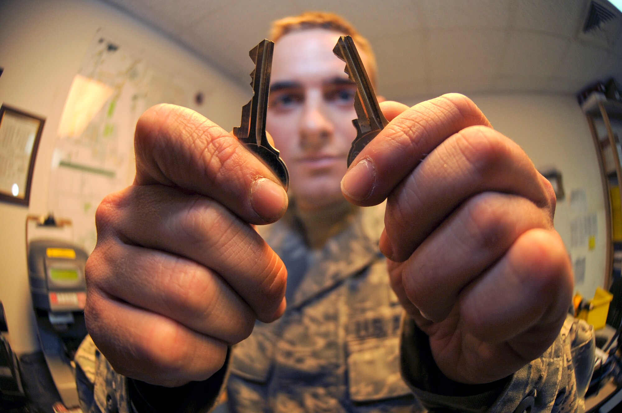 Senior Airman Jesse Testudine, a locksmith with the 379th Expeditionary Civil Engineer Squadron, checks for any discrepancies on a newly made key by comparing it to the original, Feb. 25, 2009, in an undisclosed location in Southwest Asia.  Airman Testudine and fellow locksmith's make around 430 keys a month for new personnel, new building structures, and to replace lost keys.  Airman Testudine is native to Baltimore, M.D. and is deployed from Misawa Air Base, Japan in support of Operations Iraqi and Enduring Freedom and Combined Joint Task Force - Horn of Africa.  (U.S. Air Force Photo by Staff Sgt. Joshua Garcia/released)