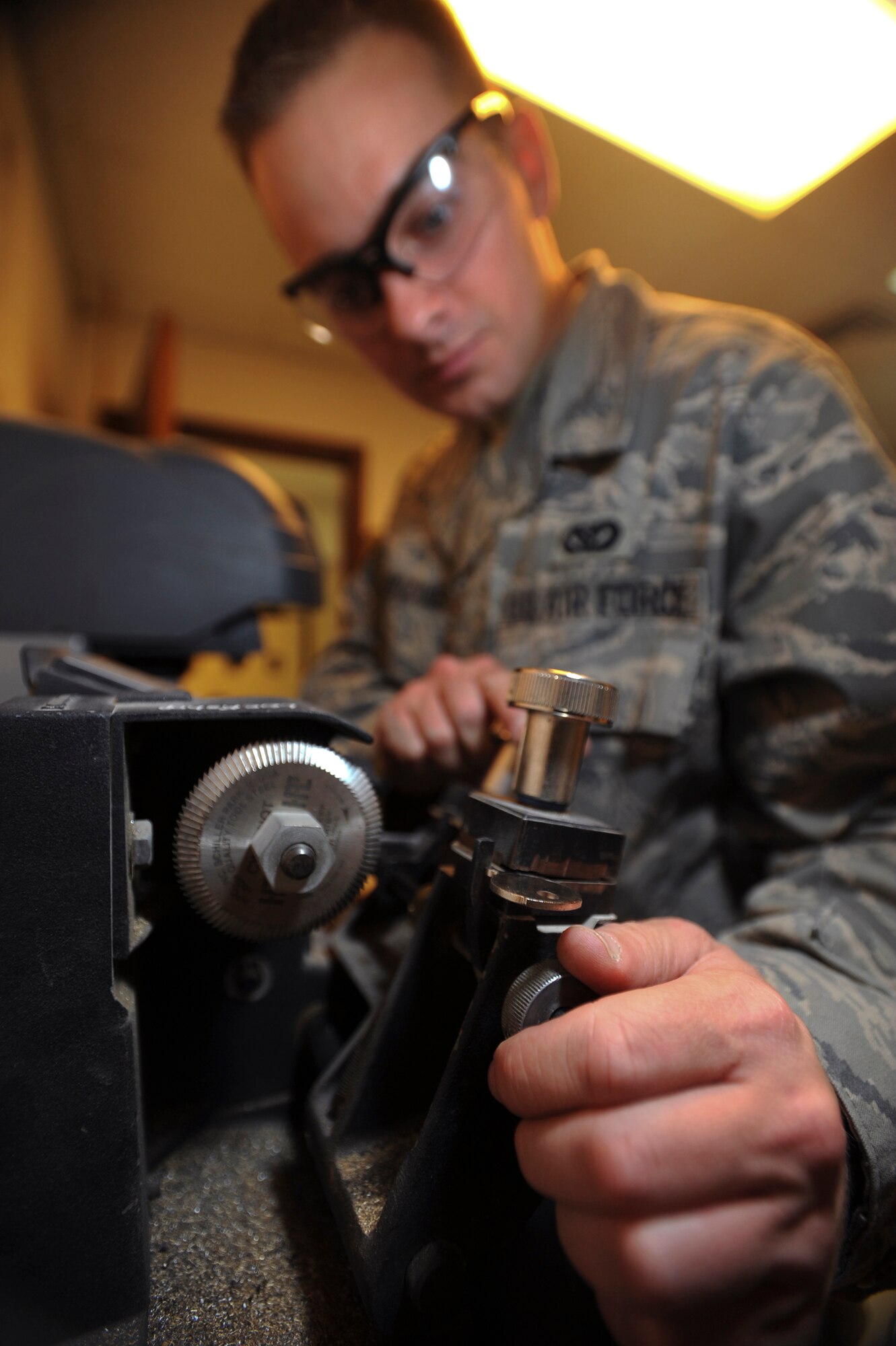 Senior Airman Jesse Testudine, a locksmith with the 379th Expeditionary Civil Engineer Squadron, loads and adjust the master and blank in a key cutting machine to make a key for a customer, Feb. 25, 2009, in an undisclosed location in Southwest Asia.  Airman Testudine and fellow locksmith's make around 430 keys a month for new personnel, new building structures, and to replace lost keys.  Airman Testudine is native to Baltimore, M.D. and is deployed from Misawa Air Base, Japan in support of Operations Iraqi and Enduring Freedom and Combined Joint Task Force - Horn of Africa.  (U.S. Air Force Photo by Staff Sgt. Joshua Garcia/released)