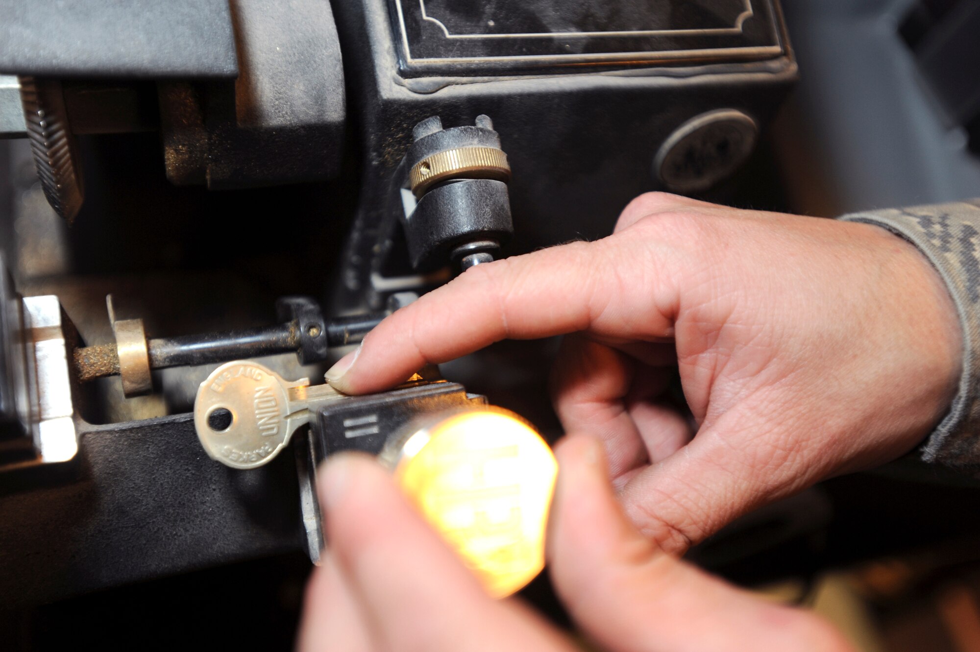 Senior Airman Jesse Testudine, a locksmith with the 379th Expeditionary Civil Engineer Squadron, adjusts the master key in a key cutting machine to make a key for a customer, Feb. 25, 2009, in an undisclosed location in Southwest Asia.  Airman Testudine and fellow locksmith's make around 430 keys a month for new personnel, new building structures, and to replace lost keys.  Airman Testudine is native to Baltimore, M.D. and is deployed from Misawa Air Base, Japan in support of Operations Iraqi and Enduring Freedom and Combined Joint Task Force - Horn of Africa.  (U.S. Air Force Photo by Staff Sgt. Joshua Garcia/released)
