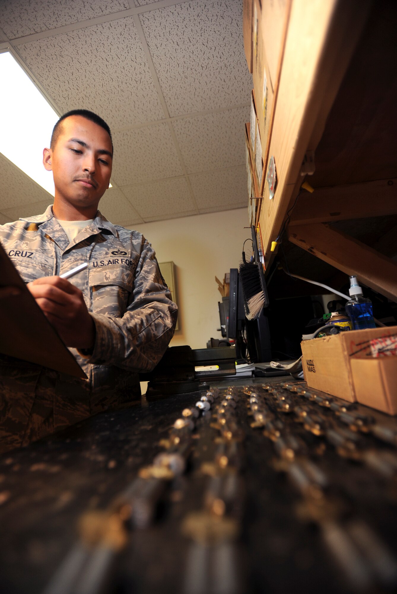 Staff Sgt. Matthew Cruz, a locksmith with the 379th Expeditionary Civil Engineer Squadron, inventories keys and their corresponding locks prior to heading out for a job, Feb. 25, 2009, in an undisclosed location in Southwest Asia.  The locks will be installed in a brand new facility that is opening on base in the near future. Sergeant Cruz is native to Tacoma, Wash. and is deployed from Pope Air Force Base, N.C., in support of Operations Iraqi and Enduring Freedom and Combined Joint Task Force - Horn of Africa.  (U.S. Air Force Photo by Staff Sgt. Joshua Garcia/released)