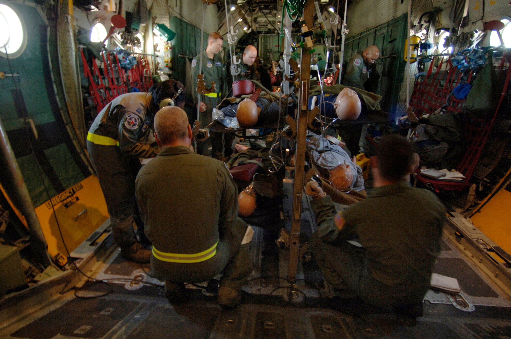 In preparation for an emergency landing training scenario aboard a C-130 Hercules flying over southern Germany, flight nurses and medical technicians follow a checklist detailing how to properly secure patients and medical equipment for a potentially rough landing. The flight-qualified healthcare providers, assigned to the 86th Aeromedical Evacuation Squadron, fly weekly with Ramstein's 37th and 38th Airlift Squadron's C-130 fleet to remain proficient in their skills.  (Department of Defense photo by Master Sgt. Scott Wager)