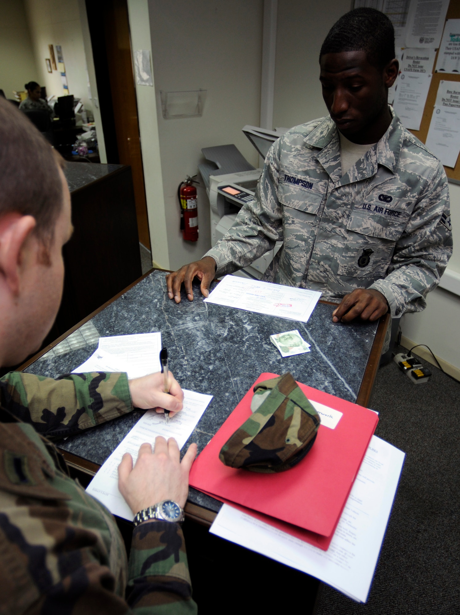 Airman 1st Class Kevin Thompson, 39th Security Forces Pass and Registration clerk, assists an Incirlik Airman in accomplishing the required paperwork for a gate pass. Members of Team Incirlik need to apply for a gate pass before the March 12 cut-off date or they will be stuck on base. (U.S. Air Force photo by Master Sgt. Ed Holzapfel)
