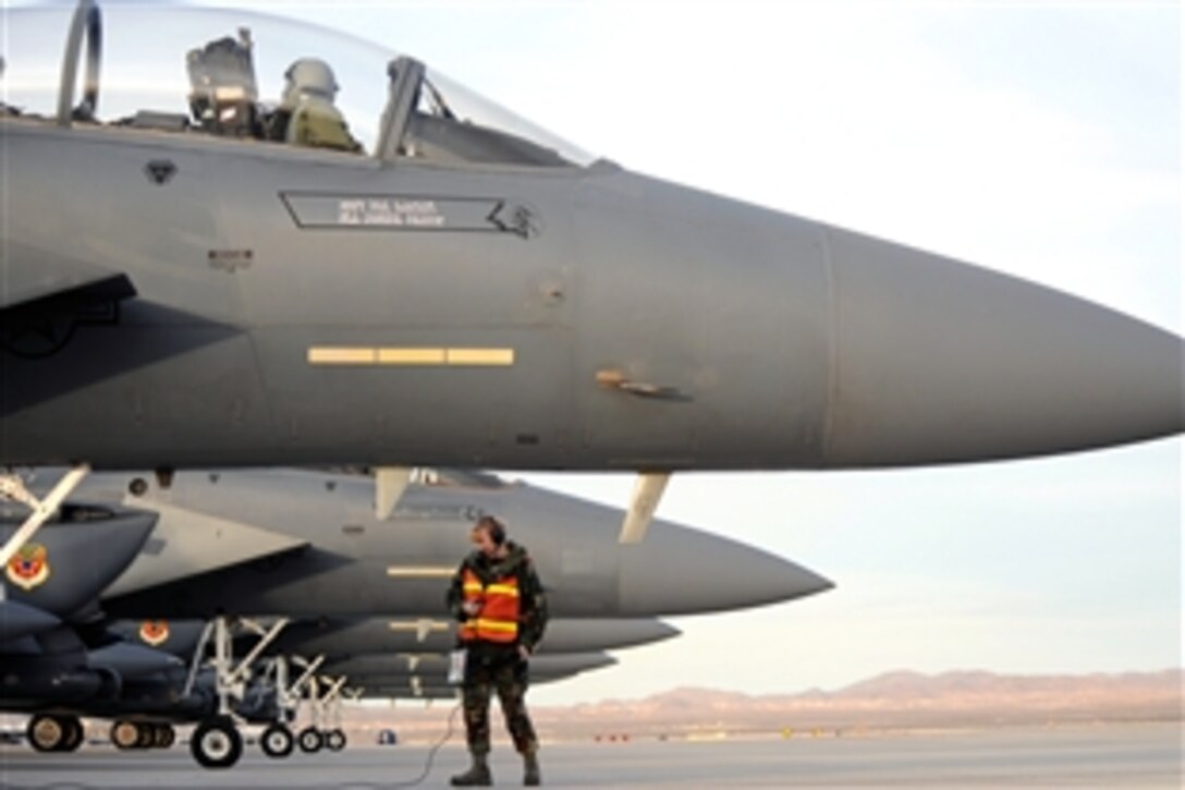 U.S. Air Force Staff Sgt. Tessa Burkett talks to the pilot of an F-15E Strike Eagle that landed on Nellis Air Force Base, Nev., for Exercise Red Flag on Feb. 20, 2009. Burkett, a crew chief, is assigned to the 366th Fighter Wing at Mountain Home Air Force Base, Idaho. Red Flag is a multinational exercise providing a realistic environment to practice combat scenarios.