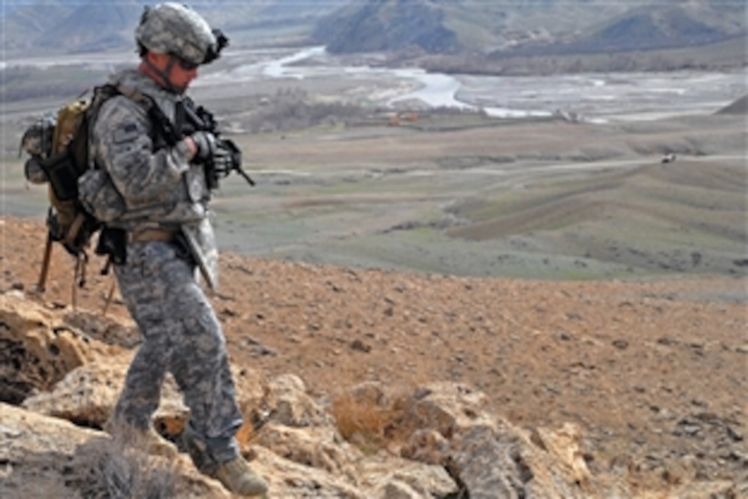 U.S. Army Spc. Jackie Greenlee goes down a mountain near Forward Operating Base Lane in Zabul province, Afghanistan, Feb. 21, 2009. Greenlee, a medic, is assigned to Company B, 1st Battalion, 4th Infantry Regiment.
