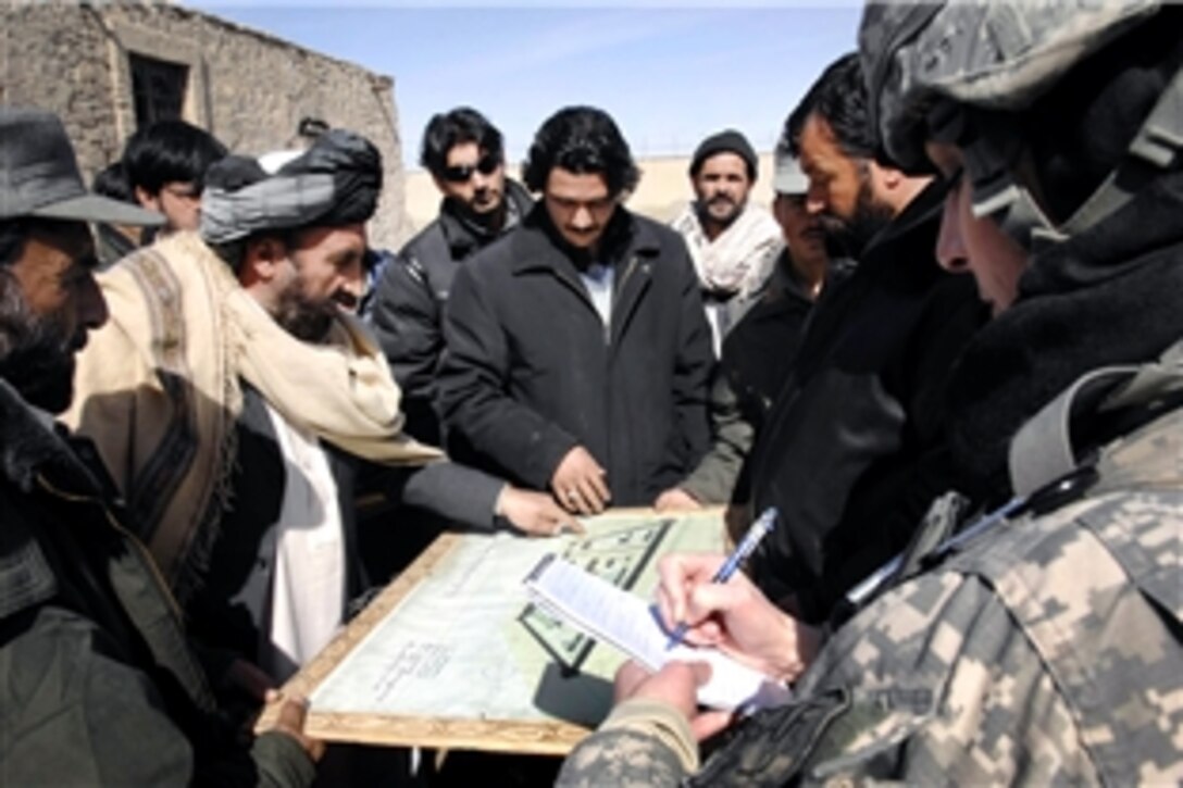 U.S. Army Capt. Megan O’Conner, a Paktia Provincial Reconstruction Team civil affairs team chief, reviews the plans for an addition to the new provincial prison during a visit to the site in Gardez City, Afghanistan, Feb. 11, 2009. The team works with local officials to decide what potential development projects should be funded. 
