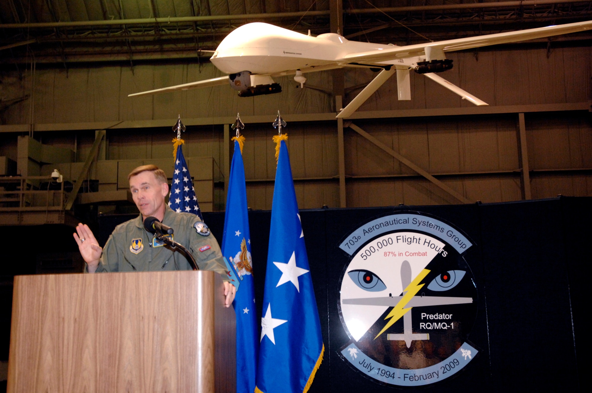 Lt. Gen. Jack Hudson, Aeronautical Systems Center commander at Wright-Patterson Air Force Base, Ohio, speaks during a Feb. 24 ceremony at the National Museum of the United States Air Force to commemorate more than 500,000 flying hours by the Predator unmanned aircraft system. The milestone was achieved by a Predator flying a combat mission over Iraq on Feb. 18.  Suspended above the general is a Predator on display in the museum's modern flight gallery. (U.S. Air Force photo/Al Bright)