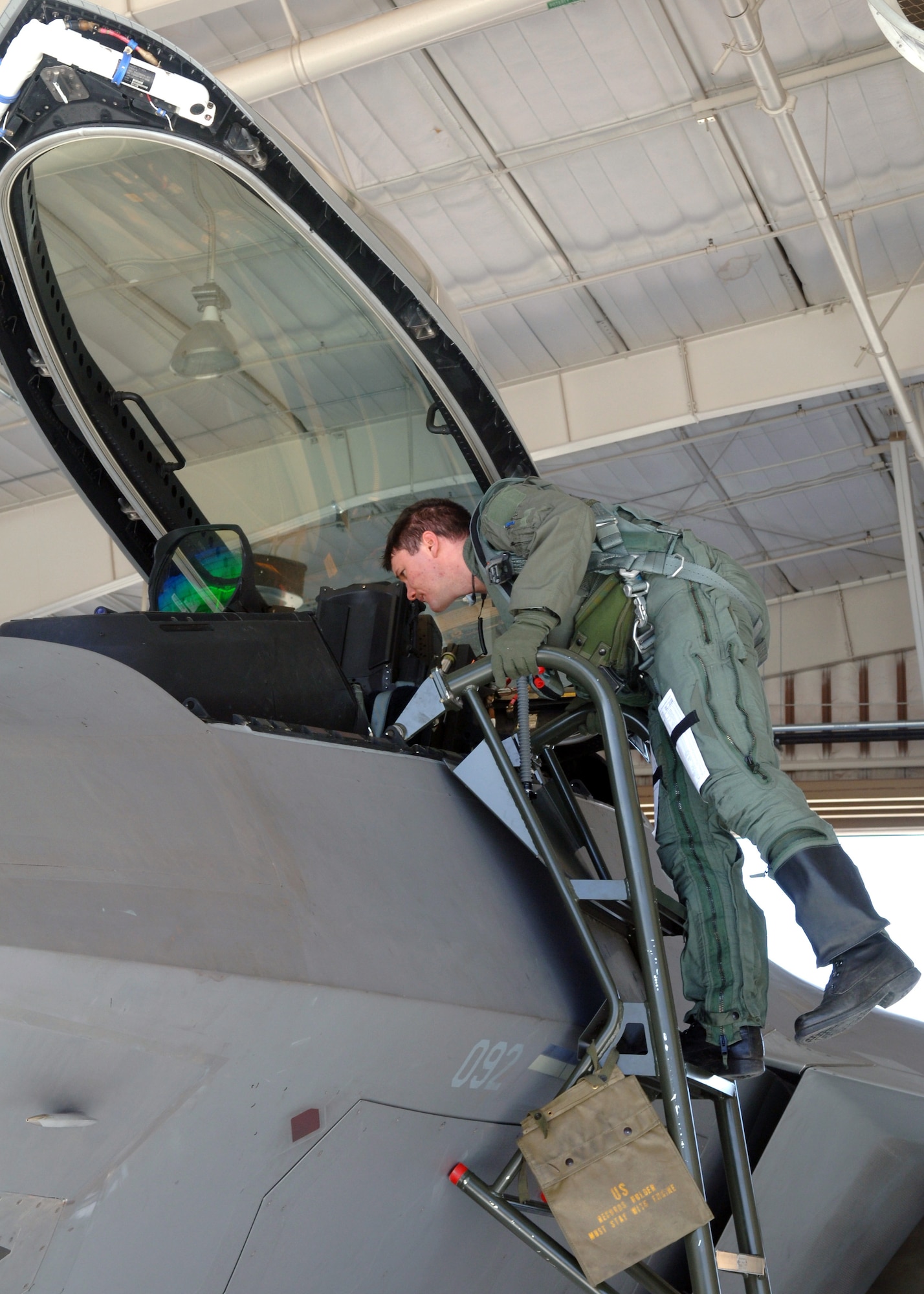 Captain Ryan Owen, 7th Fighter Squadron pilot, climbs out of an F-22A Raptor at Holloman Air Force Base, N.M., Feb. 26, after arriving back from a mock deployment to Anderson Air Base, Guam. As part of a base-wide exercise, pilots flew Raptors in preparation for a mock deployment. (U.S. Air Force photo/Airman 1st Class Veronica Salgado)