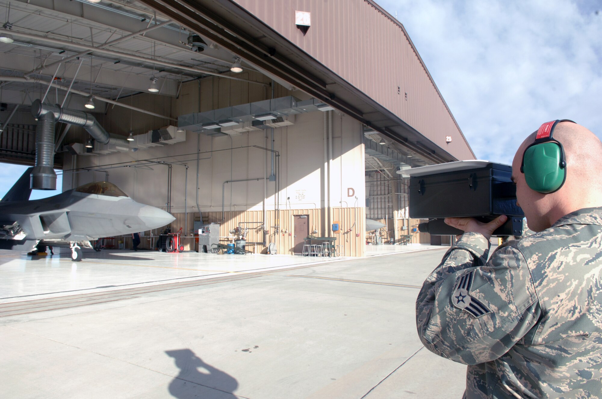 Senior Airman Joseph Davis, 7th Aircraft Maintenance Squadron, uses an identification friend or foe (IFF) test set to check the transponders of an F-22A Raptor at Holloman Air Force Base, N.M., Feb. 26. As part of a base-wide exercise, maintainers generated preparation for a mock aircraft deployment. (U.S. Air Force photo/Airman 1st Class Veronica Salgado)