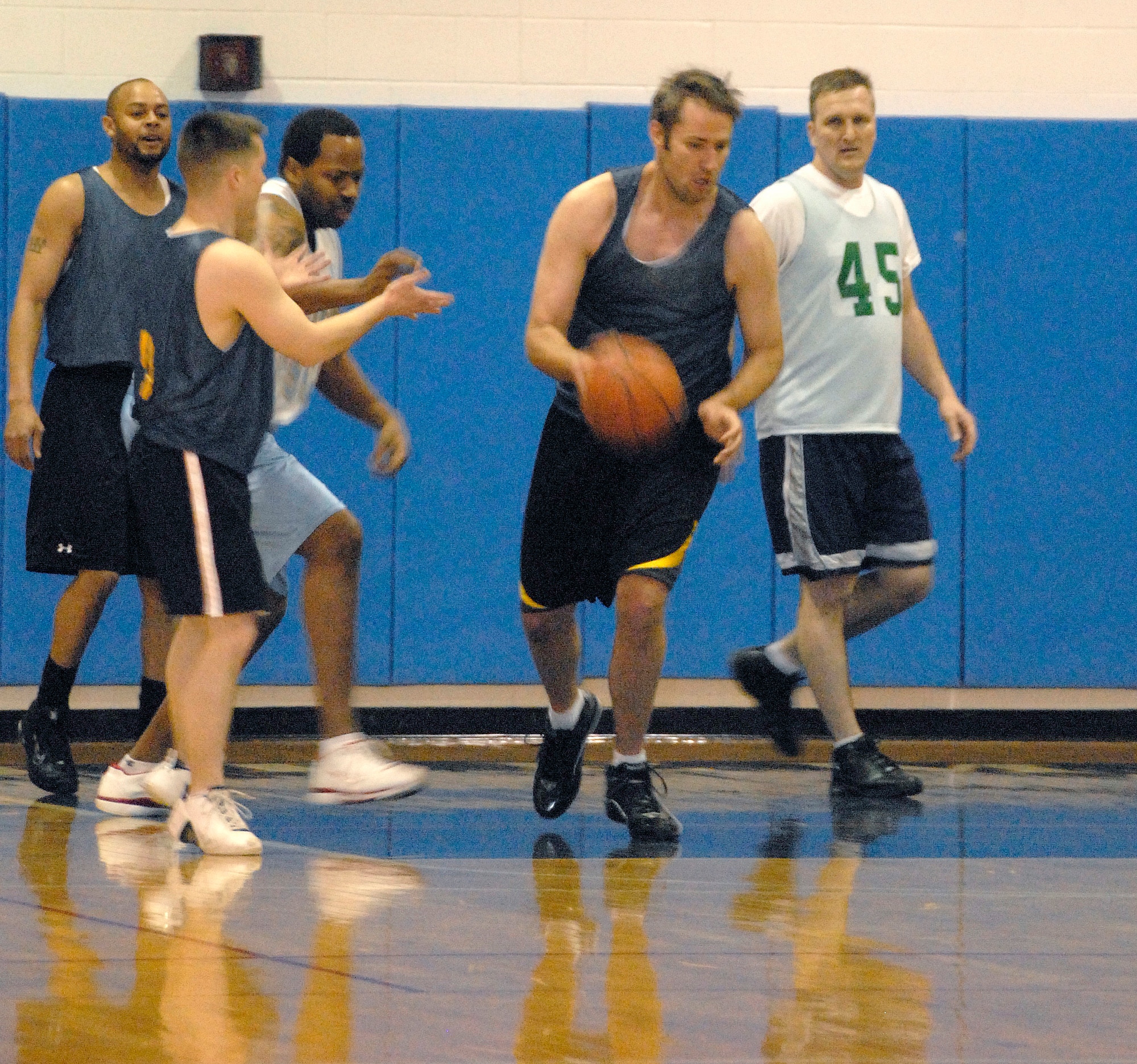 John Schriever, 442nd Fighter Wing, dribbles the ball up court after making a defensive rebound in the Whiteman Air Force Base Over-30 Extramural Basketball championship game Feb. 23 in the base gymnasium.  The 442nd Fighter Wing won the championship for the fifth time in seven years after beating the 509th Force Support Squadron team 45 to 42 in overtime.  The 442nd Fighter Wing is an Air Force Reserve A-10 unit based at Whiteman.  (U.S. Air Force photo, Maj. David Kurle)