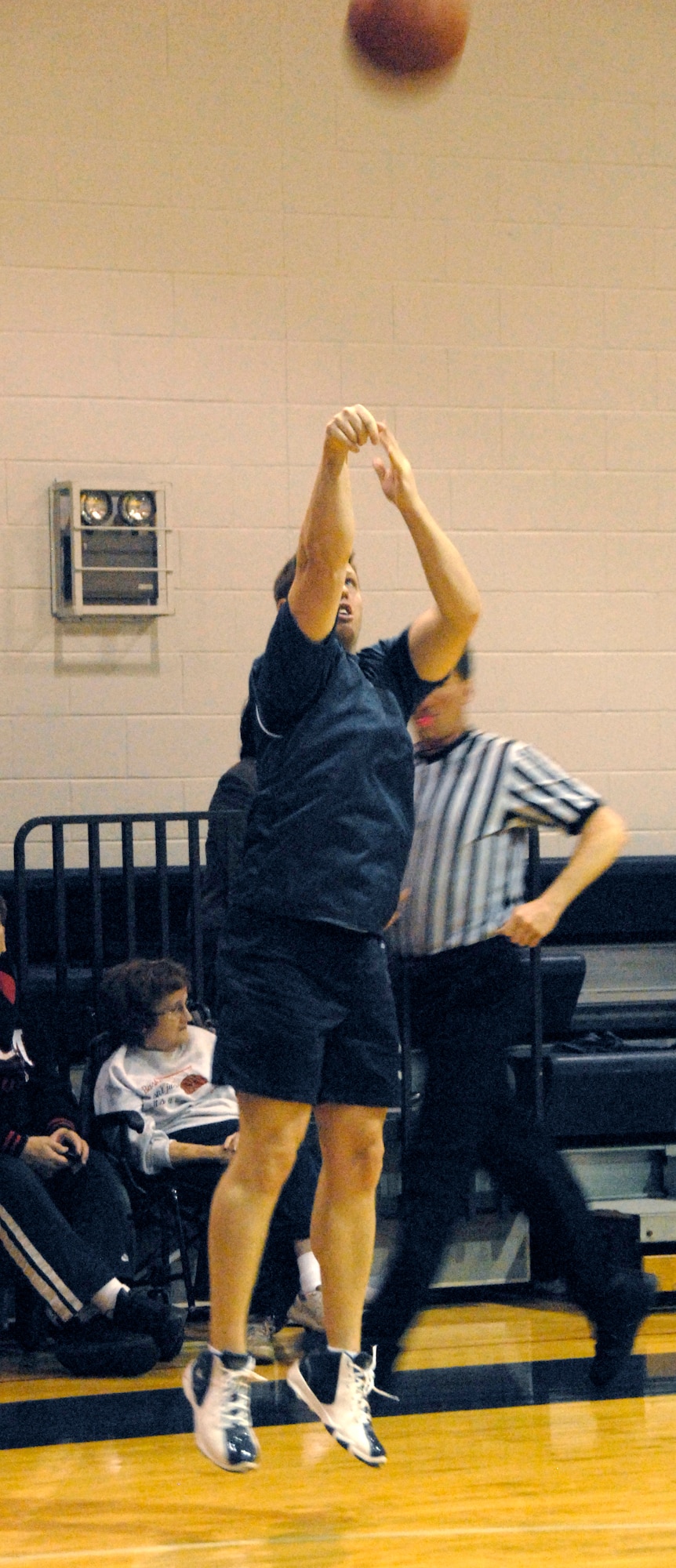 Stephen Nester, 442nd Fighter Wing, launches a 3-point shot in the third quarter of the championship game for the Whiteman Air Force Base Over-30 Extramural Basketball league.  The 442nd FW's 3-point shooting helped bridge the gap with the 509th Force Support Squadron to tie the game in regulation.  The 442nd went on to win the game in overtime, 45-42, for its fifth championship in the last seven seasons.  (U.S. Air Force photo/Maj. David Kurle)
