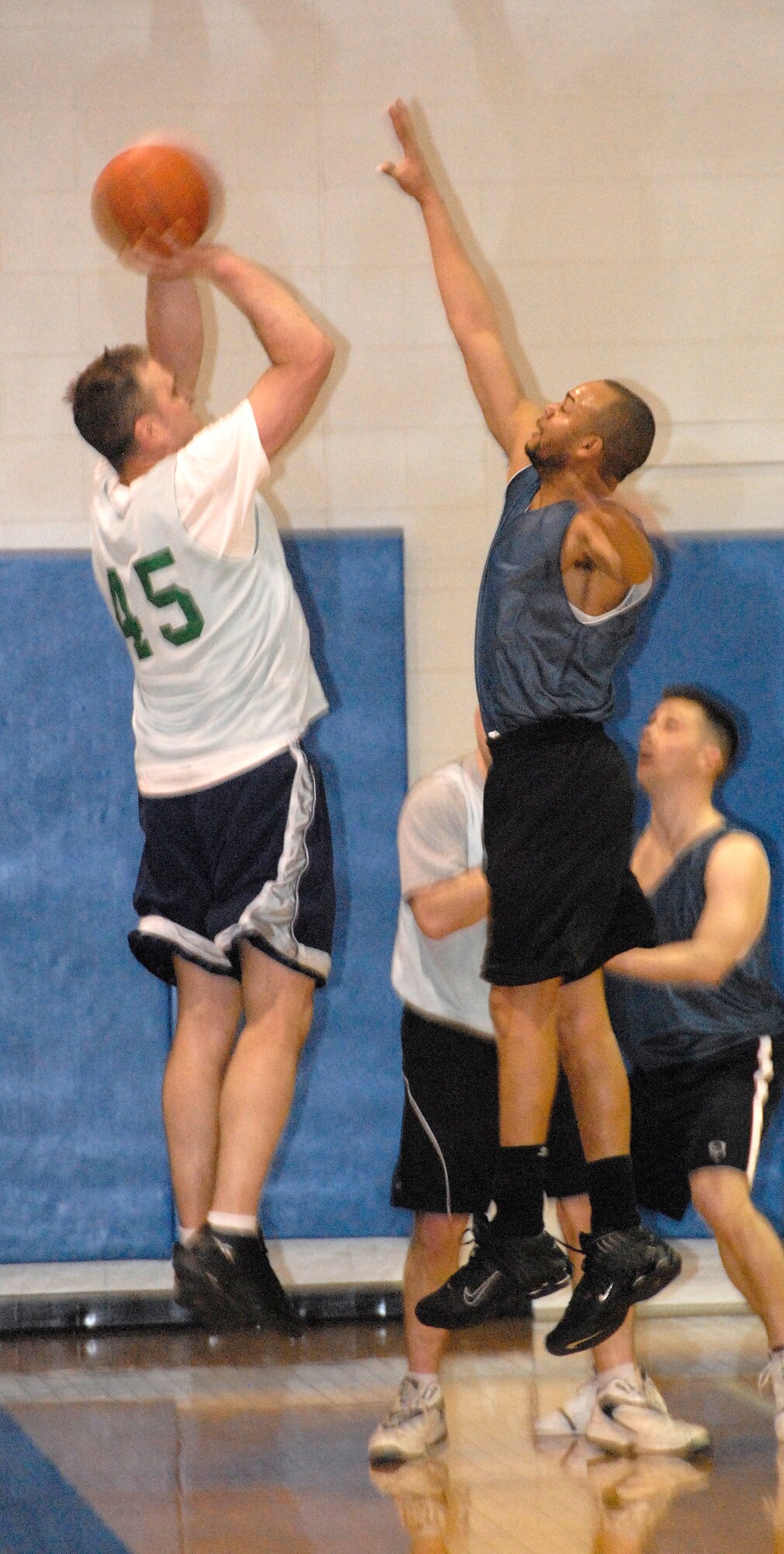 Kellie Askew, 442nd Fighter Wing, tries to block a shot by 509th Force Support Squadron player Robert Hale during the championship game in the Whiteman Air Force Base over-30 Extramural Basketball League.  The 442nd won the championship for the fifth time in seven years, beating the FSS squad 45-42 in overtime.  Hale led the FSS in scoring with 13 points, while Askew scored five.  (U.S. Air Force photo/Maj. David Kurle) 