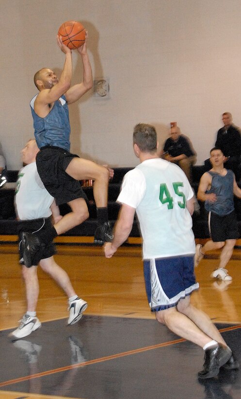 Kellie Askew, 442nd Fighter Wing, makes a running jump shot during the first half of the Whiteman Air Force Base Over-30 Extramurall Basketball championship game Feb. 23.  Askew ended up with five points in the game, which the 442nd squad won 45 to 42 over the 509th Force Support Squadron.  The game went to overtime after a Jeff Pahl sank a three-point shot with one second left in regulation to tie-up the score.  This is the fifth championship for the 442nd team in seven years.  (U.S. Air Force photo/Maj. David Kurle) 