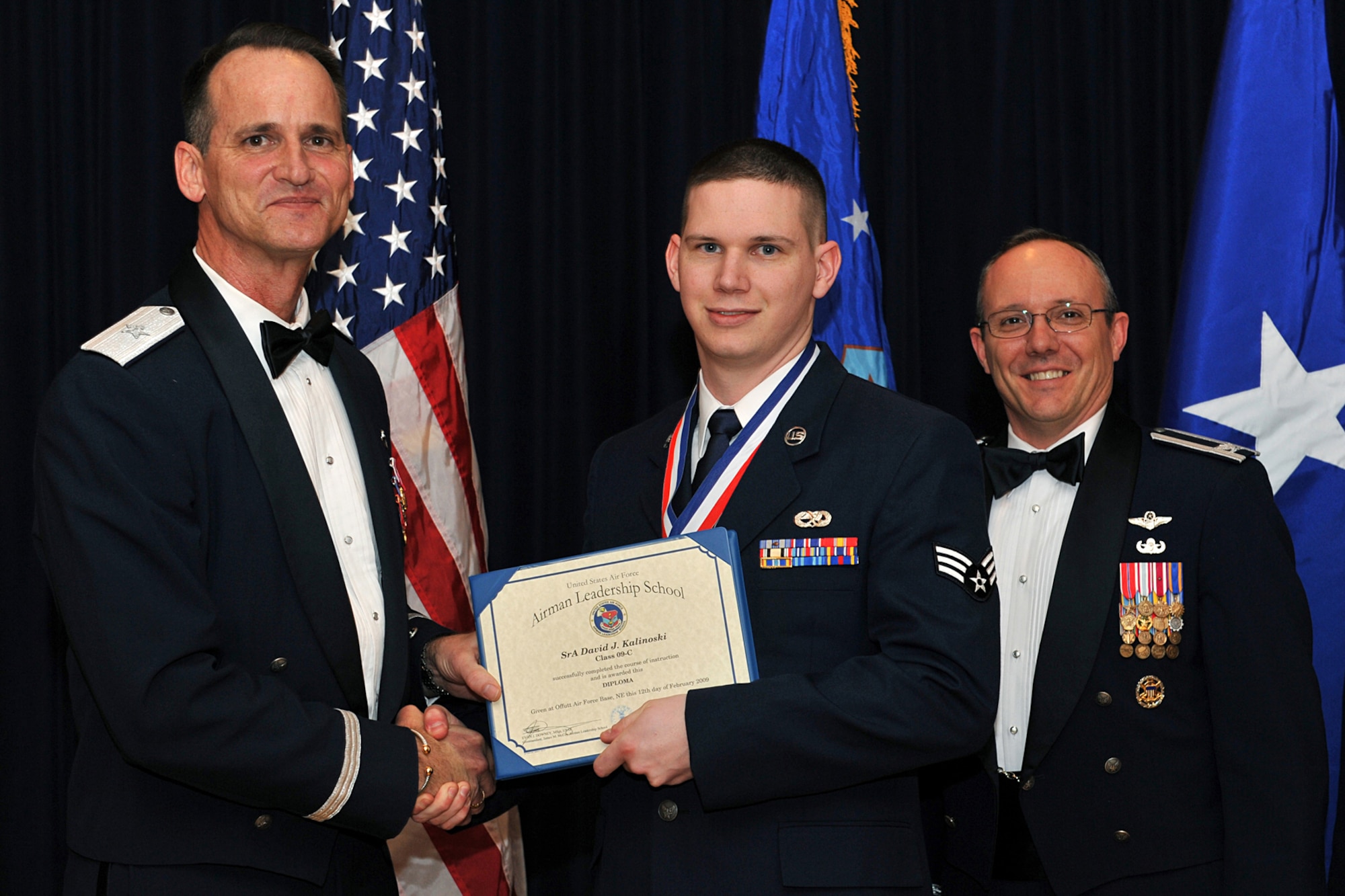 OFFUTT AIR FORCE BASE, Neb. -- Brig. Gen. James Jones, 55th Wing commander, and Col. Robert Maness, 55th Wing vice commander, congratulate Senior Airman David Kalinoski from the 97th Intelligence Squadron, after he successfully graduated from the James M. McCoy Airman Leadership School here Feb. 12. Through dedication and hard work, Airman Kalinoski and the 37 other graduates have enhanced their leadership skills to guide the next generation of airman coming into the Air Force. 

