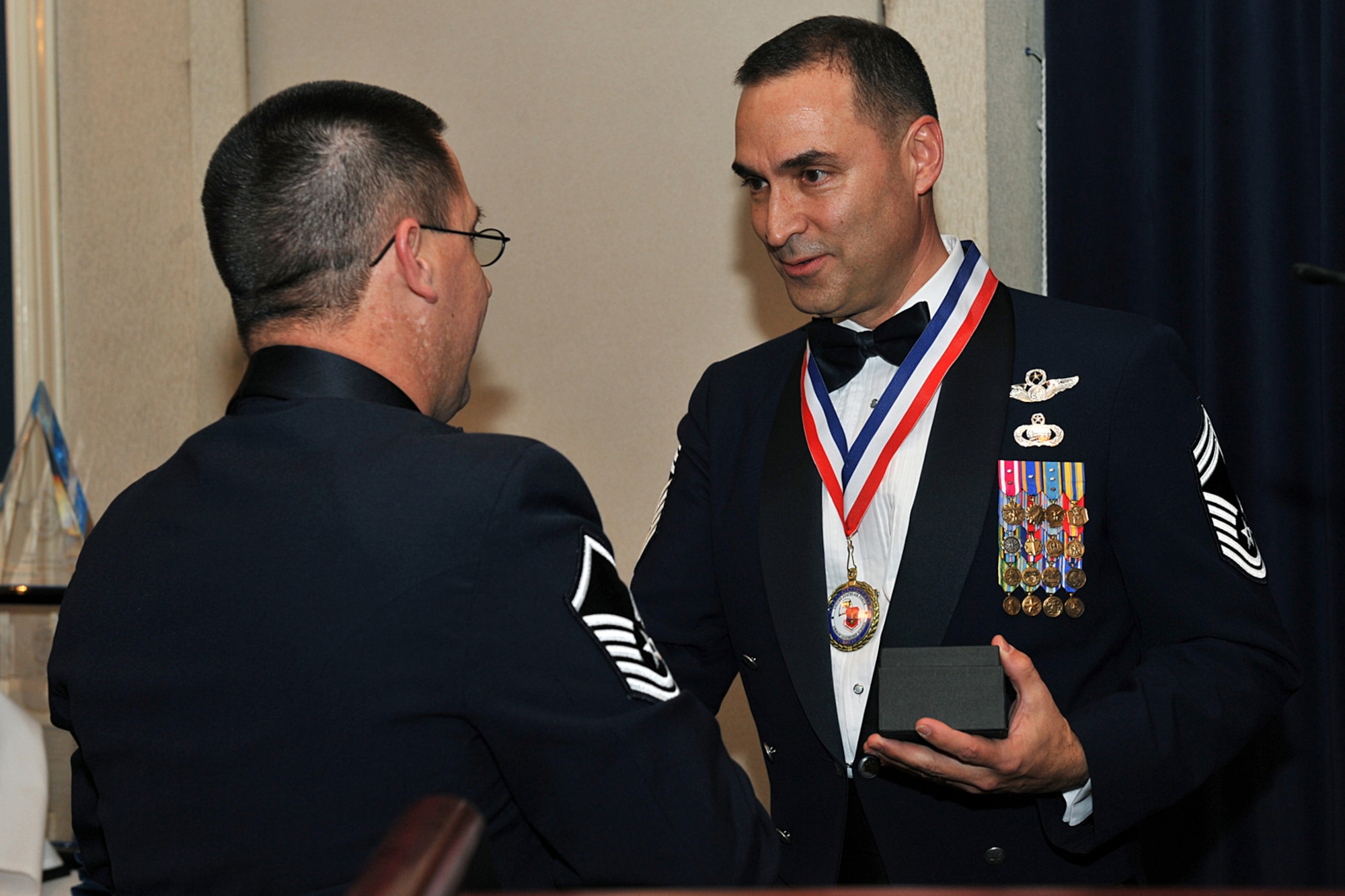 OFFUTT AIR FORCE BASE, Neb., --  Master Sgt. Evan Downey, commandant of the James M. McCoy Airman Leadership School, presents Chief Master Sgt. Dean Howell, superintendent of 55th Operations Group, with a thank you gift for his mentoring of the James M. McCoy Airman Leadership School class 09- C Feb. 12. Through four weeks of dedication and hard work, 37 graduates have enhanced leadership skills to guide this next generation of airman coming into the Air Force.  