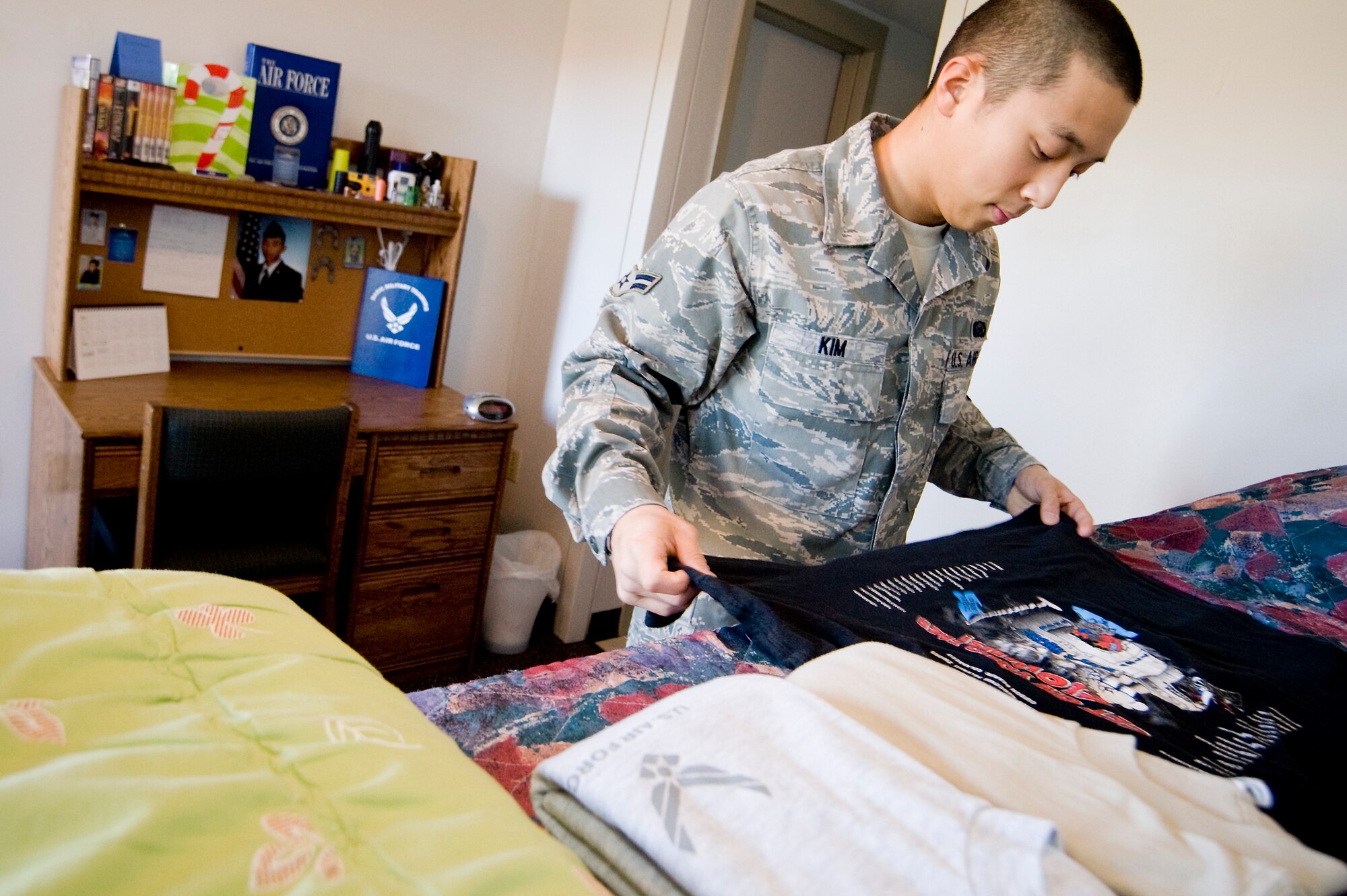 Airman 1st Class Daniel Kim, 62nd Force Support Squadron, folds his laundry in preparation for a dorm inspection. Airman Kim was recently presented a coin after a wing inspector was amazed with how clean he kept his room. (U.S. Air Force photo/Abner Guzman)