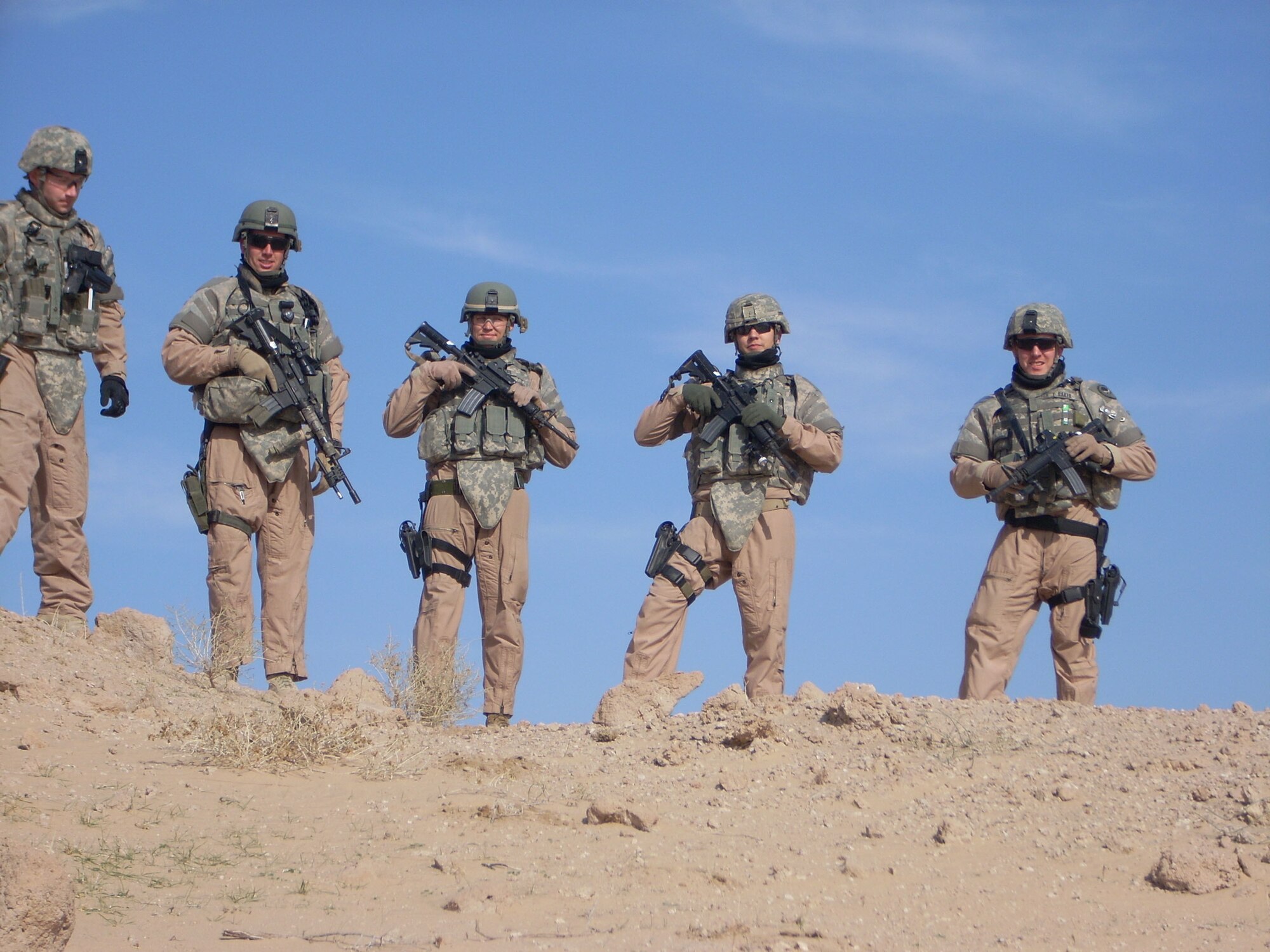 Members of Tech. Sgt. Kevin Akers' combat patrol element stop for a photo during a recent deployment to Iraq. Sergeant Akers was awarded the Bronze Star for his actions while on duty in Iraq as a squad leader. From left to right near Camp Bucca, Iraq,  Senior Airman Stephen Miller, Staff Sgt. Jason Vanmeteren, Sergeant Akers, Staff Sgt. Michael Berg and Airman 1st Class Sean Baker.        