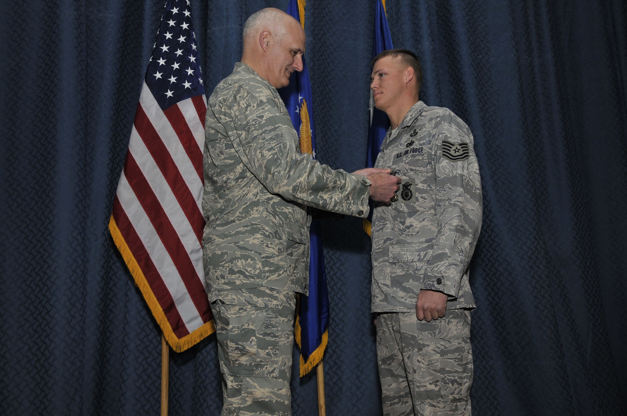 Maj. Gen. Roger Burg, 20th Air Force commander,  presents the Bronze Star Medal to Tech. Sgt. Kevin Akers, 341st Security Forces Squadron, Feb. 25, for his actions while on duty in Iraq. General Burg was at Malmstrom to conduct a commander's call and presented the medal prior to the start of that event. (U.S. Air Force photo/John Turner)