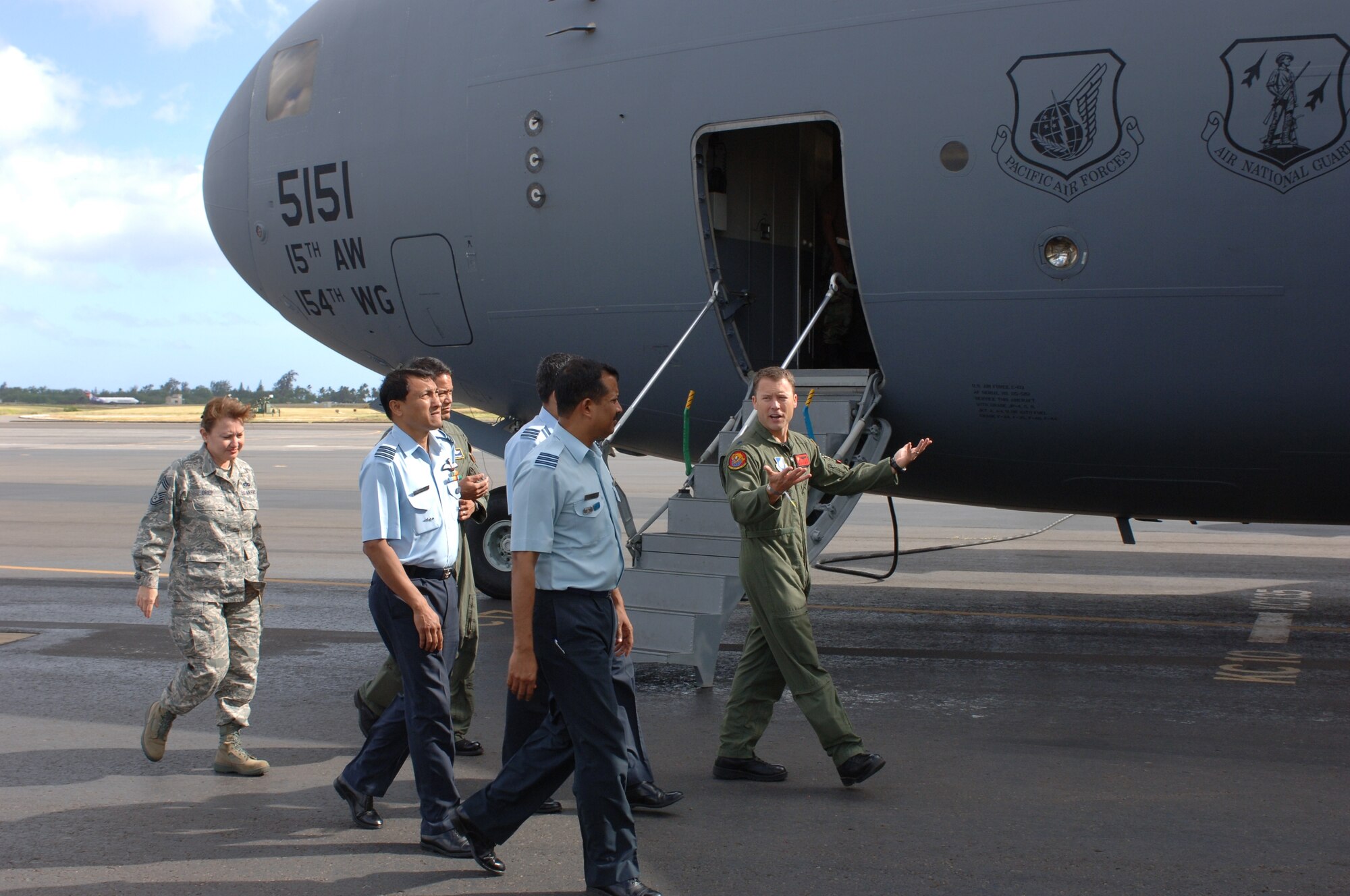 Lt. Col. Casey Easton, 535th Airlift Squadron commander, explains the features, functions, and structure of a C-17 Globemaster III to visiting Indian Air Force members Anup Kumar Dutta, KV Surendran Nair, and SK Vidnate. (U.S. Air Force photo by Oscar Hernandez)