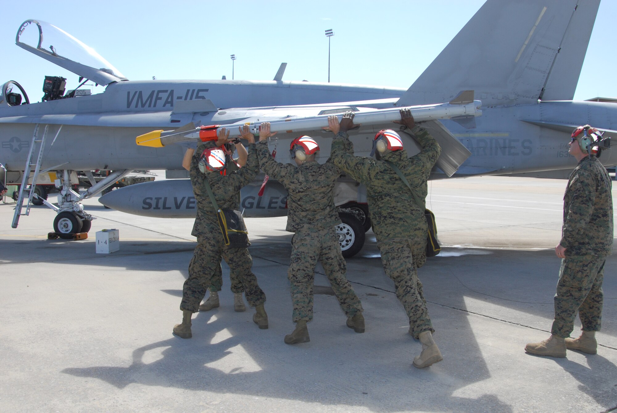 Ordance Shop personnel load a live AIM-9X missile on a Marine F/A-18, Feb. 17.  The F/A-18 Squadron VMFA-115 “Silver Eagles” are based at Marine Corps Air Station in Beaufort, South Carolina and are participating in the first ever Joint Combat Archer Air-to-Air Weapons Systems Evaluation Program here at Tyndall Air Force Base.  (U.S. Air force photo by Lisa Norman)
