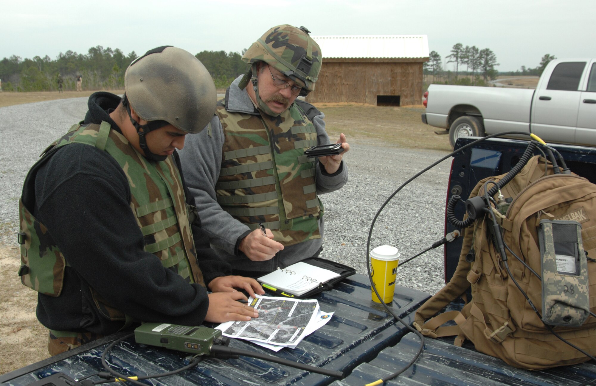 Mr. Timm Finn (right), a contractor specializing in the Tactical Air Control Party, Close Air Support System, trains Staff Sgt. Jose Ibarra of the 548th Combat Training Squadron's Detachment 1 at Fort Polk, La., on how the digital system is used to relay information to inbound pilots. (U.S. Air Force photo/Staff Sgt. Jake Richmond)