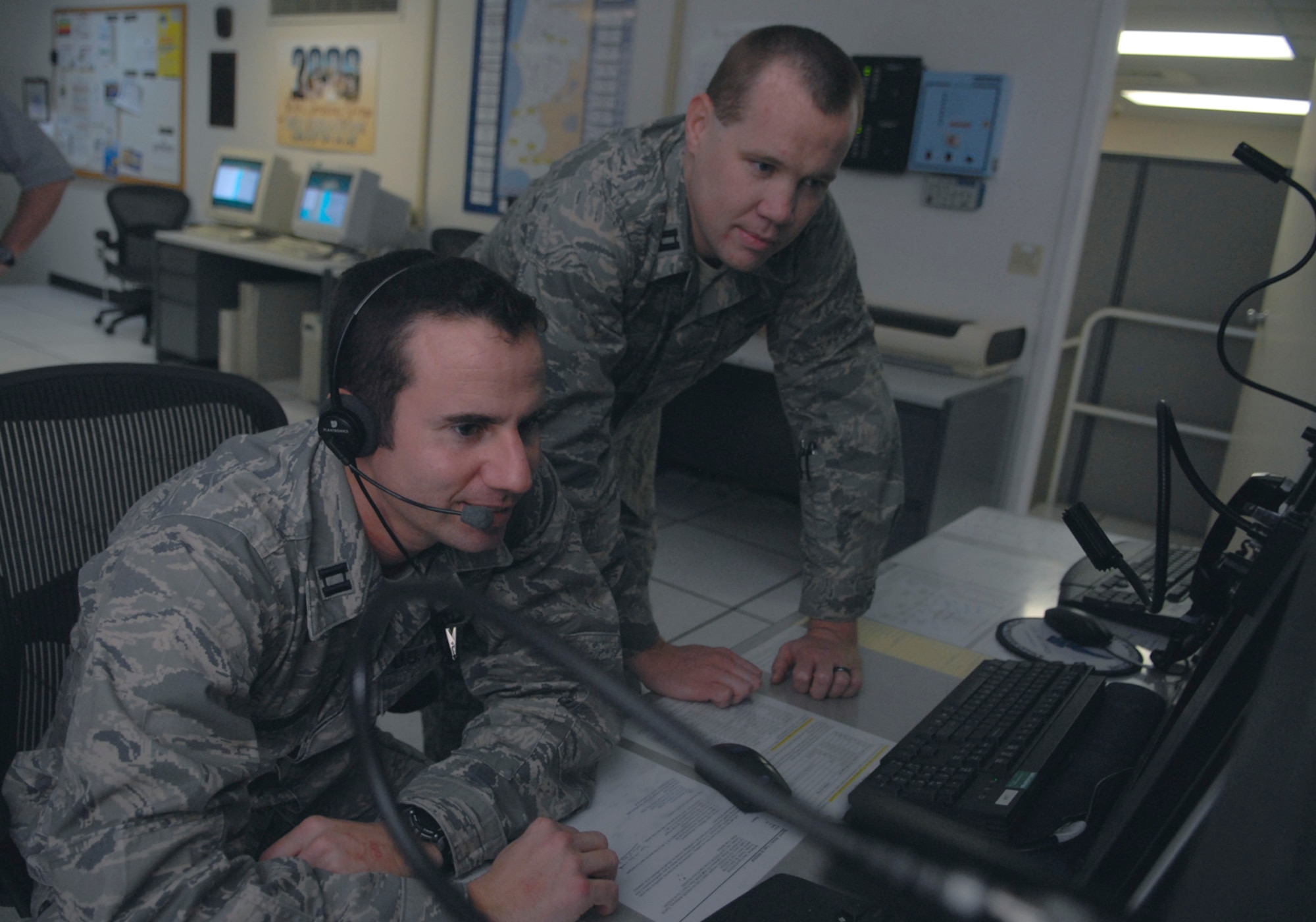 VANDENBERG AIR FORCE BASE, Calif. -- Capt. Damon Vorhees and Capt. Tyler Brock, from the 30th Weather Squadron analyze weather information here Feb. 25. (U.S. Air Force photo / Senior Airman Christopher Hubenthal)