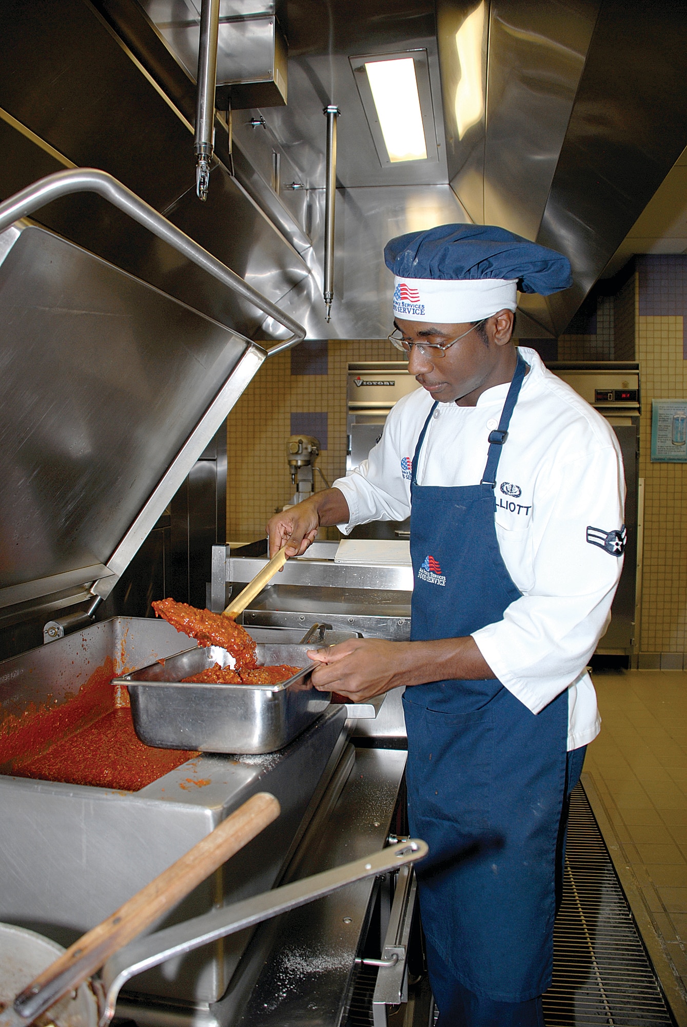 Airman 1st Class Terrance Elliott, 56th Services Squadron Food Service specialist, prepares spaghetti meat sauce. (U.S. Air Force photo/ Airman 1st Class Traci Forte)