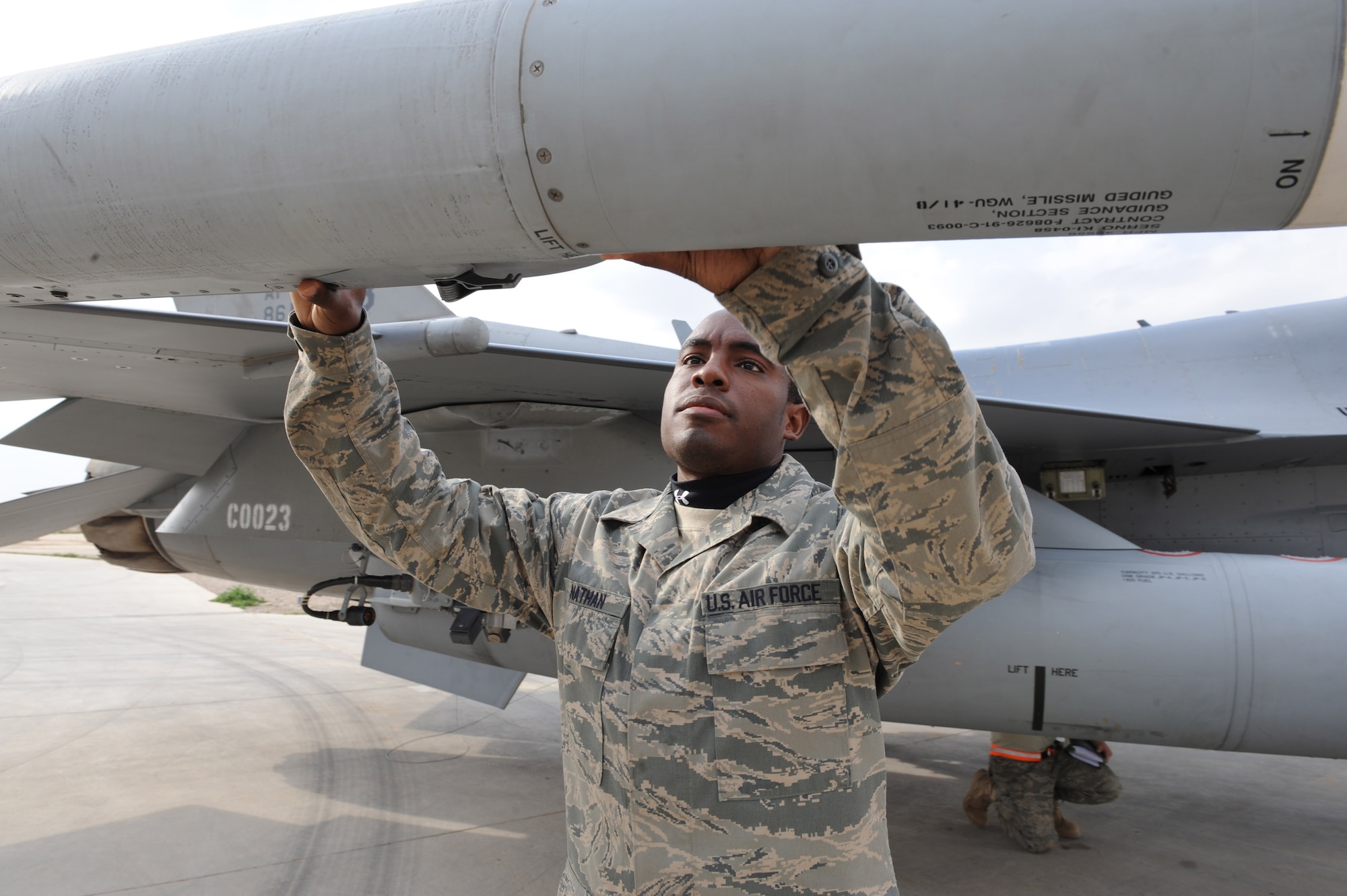 Staff Sgt. Joe Nathan Jr. inspects an F-16 Fighting Falcon after its return from a mission Feb. 23 at Joint Base Balad, Iraq. As an F-16 weapons loader, Sergeant Nathan is responsible for loading missiles onto the F-16 as well as performing post-load inspections on the weapons. Sergeant Nathan is a 332nd Expeditionary Aircraft Maintenance Squadron Tiger Aircraft Maintenance Unit weapons loader deployed from Homestead Air Reserve Base, Fla. He is a native of Macon, Ga. (U.S. Air Force photo/Senior Airman Tiffany Trojca) 
