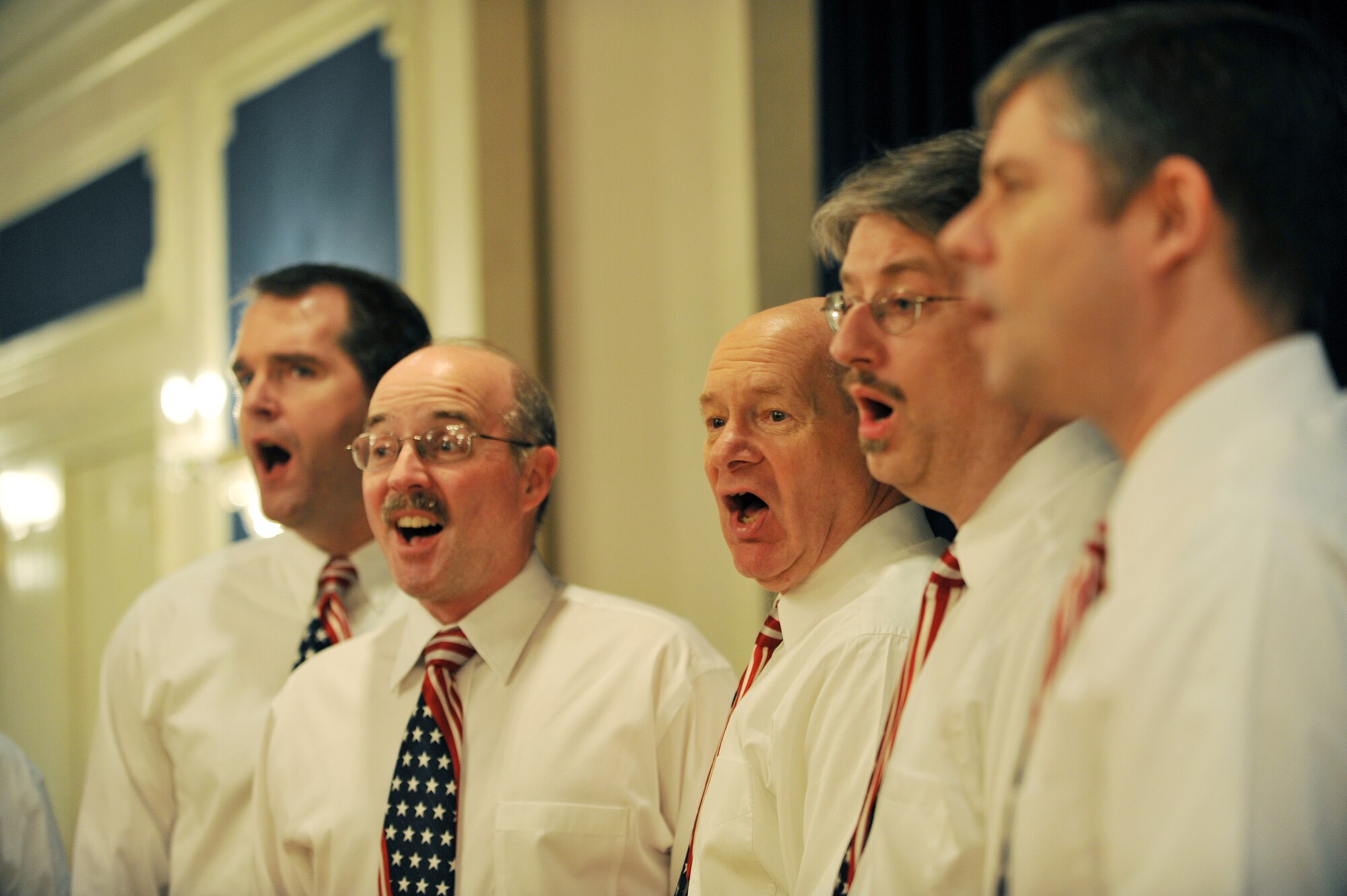 OFFUTT AIR FORCE BASE, Neb.,-- U. S. Strategic Command?s Command Performers sing God Bless America during the National Prayer Luncheon at the Patriot Club Feb. 24. Throughout this luncheon, many of Offutt?s personnel representing different faiths and backgrounds came together to pray for warriors fighting for our nation and our families. 