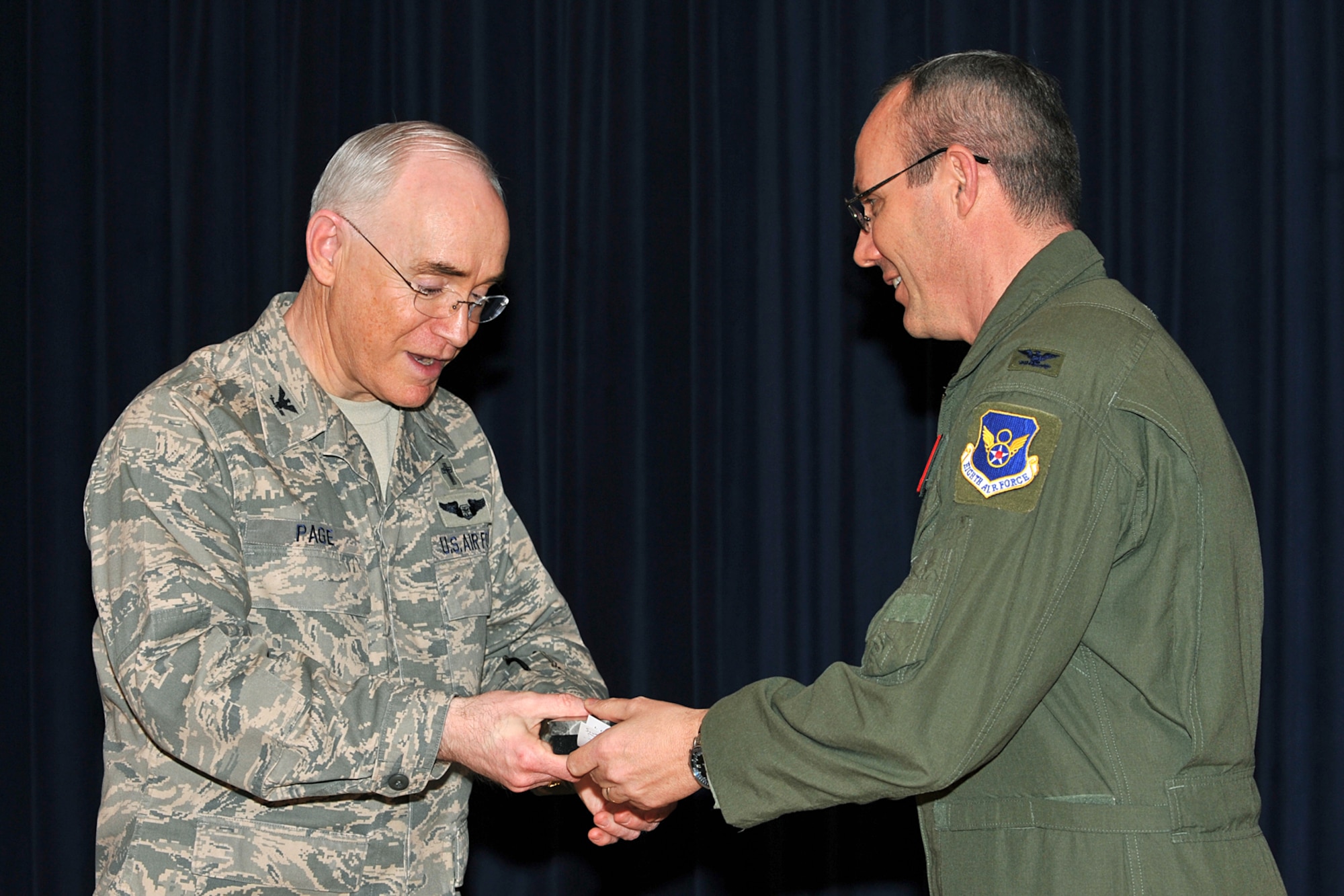 OFFUTT AIR FORCE BASE, Neb., -- Chaplain, (Col.) Bobby V. Page, command chaplain for Air Combat Command, receives a thank you gift from Col. Robert Maness, 55th Wing vice commander, for his inspiring words during the National Prayer Luncheon at the Patriot Club Feb. 24. Throughout the luncheon, many of Offutt?s personnel representing different faiths and backgrounds came together to pray for warriors fighting for our nation and our families. 

