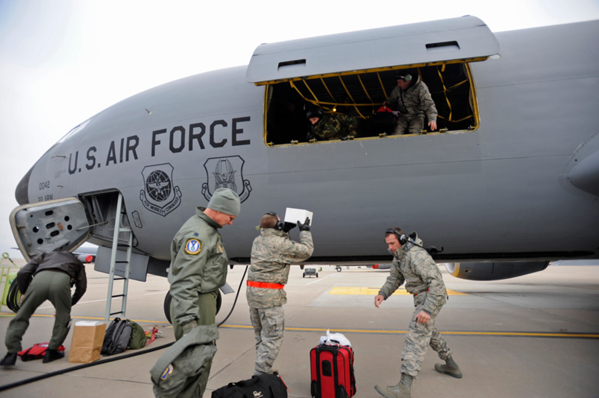 Flyers and aircraft maintenance Airmen from the 931st Air Refueling Group team up to load cargo on to a KC-135 Stratotanker prior to departing for a three-day aeromedical evacuation training exercise Friday morning. The 931st is an Air Force Reserve unit at McConnell Air Force Base, Kan. (U.S. Air Force photo/Tech. Sgt. Jason Schaap)