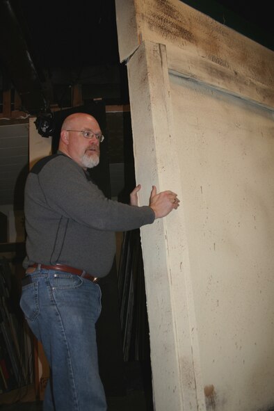 MINOT AIR FORCE BASE, N.D. -- Tim Knickerbocker, 5th Civil Engineer Squadron, moves a section of the set that he designed to roll for scene changes.  Mr. Knickerbocker and his family are all active members of Minot’s Mouse River Players, which is set to present ‘Last of the Minot Flappers’ March 5 to 8. (U.S. Air Force photo by Laurie Arellano)