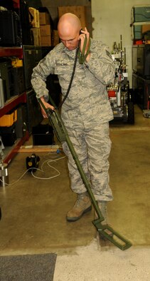 Staff Sgt. Nicholas Stehling, 115th Explosive Ordnance Disposal flight, demonstrates how to properly use a mini-mine detector at the EOD training room Feb. 07. The mini-mine detector is just one of the new pieces of equipment the EOD flight has recieved since 2005 when EOD was created at Truax Field. (U.S. Air Force photo by Master Sgt. Paul Gorman) 