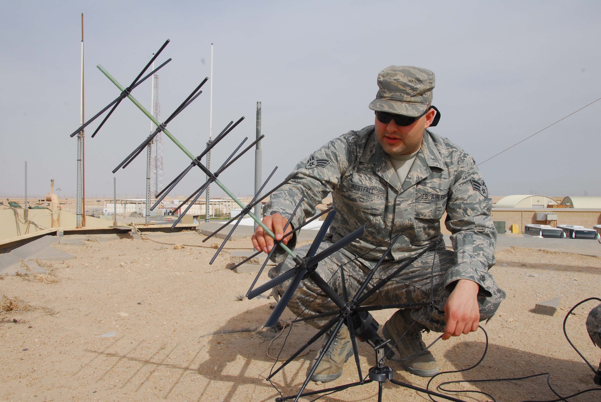 SOUTHWEST ASIA -- Senior Airman Stephon Westfall, 386th Expeditionary Communications Squadron, checks a satellite communication antenna for damage at an air base in Southwest Asia, Feb. 26. If there is any damage to the antenna, such as a bent or broken element, it can affect the performance and workability of the antenna. Airman Westfall is currently deployed from the 141st Air Refueling Wing, an Air National Guard unit, at Fairchild Air Force Base, Wash., and is originally from Spokane, Wash.  (U.S. Air Force photo/ Senior Airman Courtney Richardson)