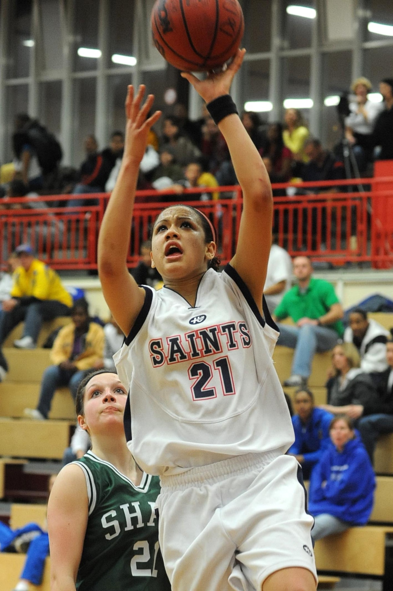 Aviano's Alyssa Lane takes it to the hoop past SHAPE's Tammy Northshield in the girls' Division II championship game. Aviano took the crown with a 50-39 win. (Photo by Michael Abrams. Used with permission from Stars and Stripes. ? 2009 Stars and Stripes)
