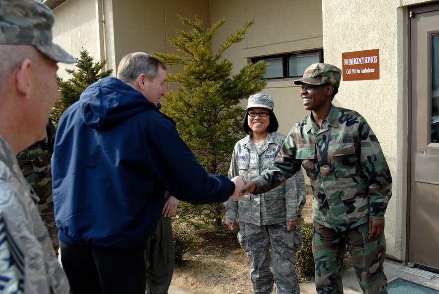 Senior Airman Wilmine Simon, 8th Medical Support Squadron welcomes former Chief Master Sergeant of the Air Force Eric W. Benken to the 8th Medical Group medical facility at Kunsan Air Base, Republic of Korea, Feb. 27 2009. Chief Benken was invited to tour Korea by Chief Master Sergeant Harry Viel, 7th Air Force command chief master sergeant. (U.S. Air Force Photo by SSgt Jason Colbert)