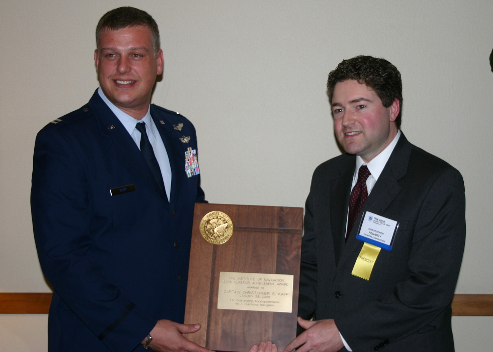 ANAHEIM, Calif. -- Dr. Christopher Hegarty (right), the Institute of Navigation president, presents the 2008 Institute of Navigation Superior Achievement Award to Capt. Christopher Kapp, a MC-130H Combat Talon II navigator who flies with the 1st Special Operations Squadron. The captain won the award for timely execution and precise navigation during operations supporting the Global War on Terror and standout performance in developing cutting edge joint aero-maritime rescue procedures. The purpose of the award is to recognize individuals making outstanding contributions to the advancement of navigation. (Courtesy photo)