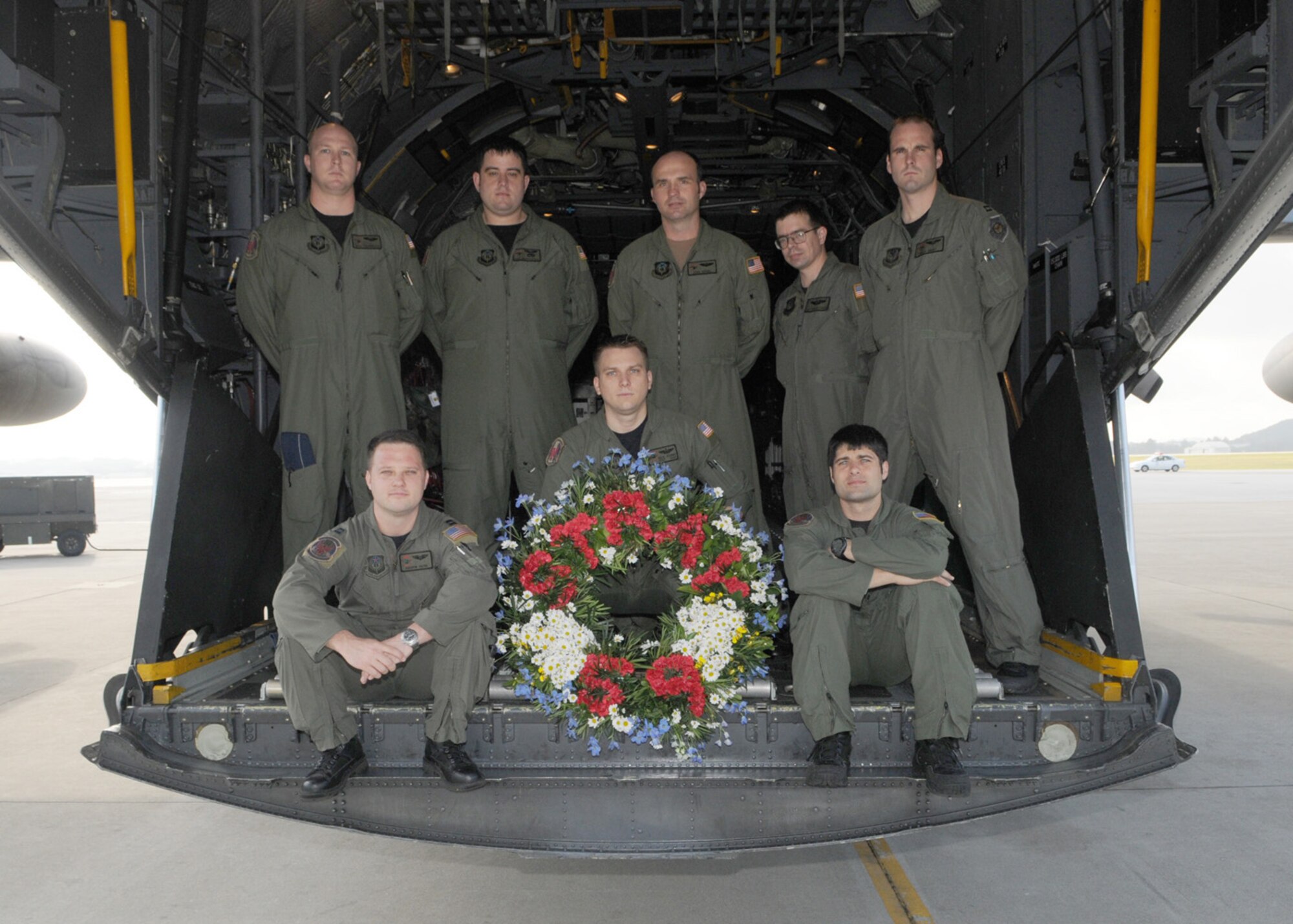 KADENA AIR BASE, Japan -- The crew of GOOSE99 poses for a photo with the memorial wreath on the back of a 1st Special Operations Squadron MC-130H Combat Talon II here Feb. 26 before flying a memorial flight to honor fallen brethren that were lost 28 years ago when a 1st SOS MC-130E, call sign STRAY59, crashed during an exercise killing eight crew members and 15 passengers. The crew of GOOSE99 flew from here to reach the exact coordinates of the crash site to release the ceremonial wreath. The memorial flight has been flown every year since the tragic accident in 1981. The crew members of GOOSE99 are (from left to right): Back row:  Capt. Houston Hodgkinson, Staff Sgt. Matthew Furtick, Maj. John Rensel, Staff Sgt. Christopher DeAngelis, and Capt. Richard Obert.   Front row: Capt. Andrew Payne, Staff Sgt. Nicholas Adams, and Staff Sgt. Steve Presler. (U.S. Air Force photo by Tech. Sgt. Aaron Cram)