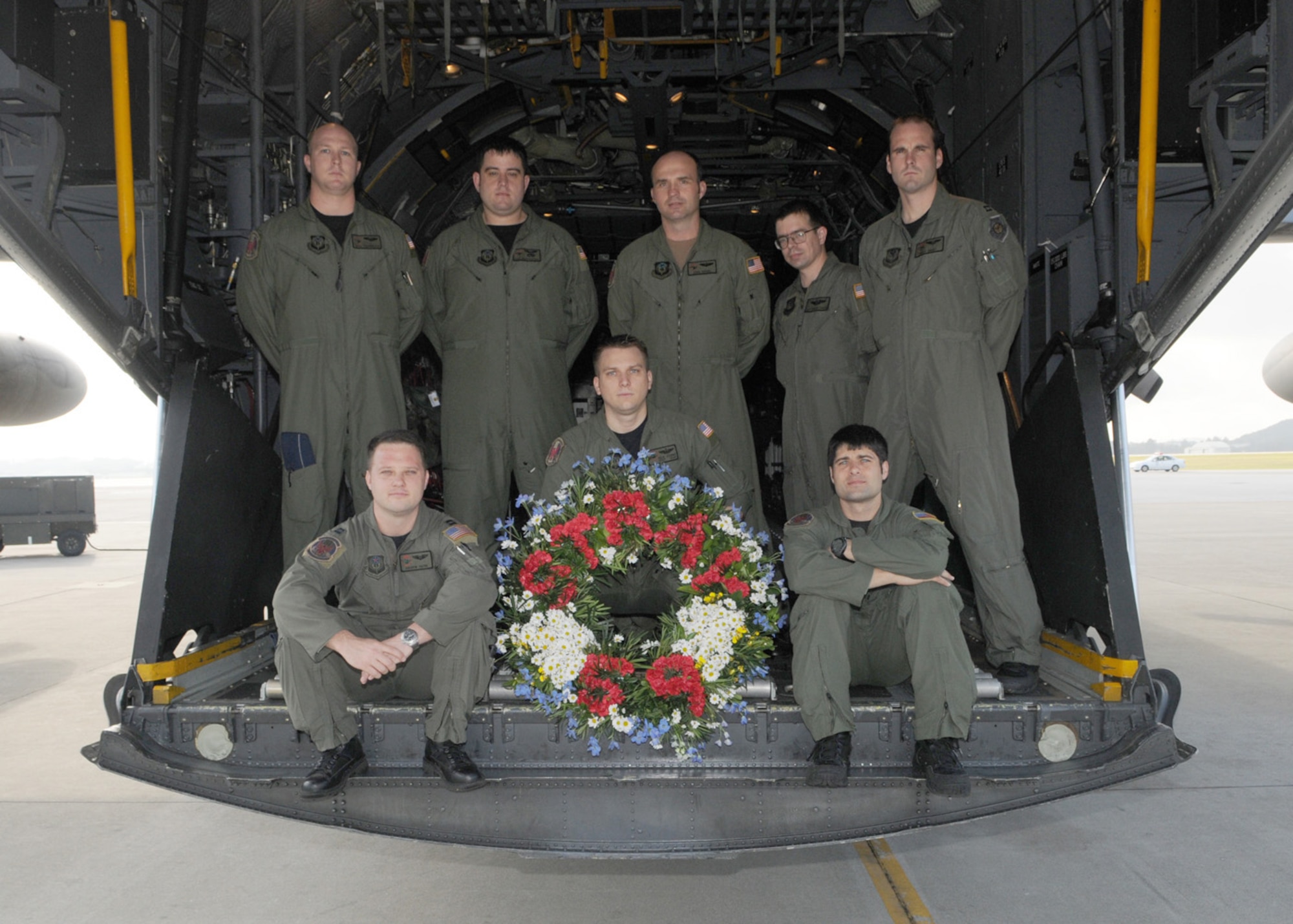 KADENA AIR BASE, Japan -- The crew of GOOSE99 poses for a photo with the memorial wreath on the back of a 1st Special Operations Squadron MC-130H Combat Talon II here Feb. 26 before flying a memorial flight to honor fallen brethren that were lost 28 years ago when a 1st SOS MC-130E, call sign STRAY59, crashed during an exercise killing eight crew members and 15 passengers. The crew of GOOSE99 flew from here to reach the exact coordinates of the crash site to release the ceremonial wreath. The memorial flight has been flown every year since the tragic accident in 1981. The crew members of GOOSE99 are (from left to right): Back row:  Capt. Houston Hodgkinson, Staff Sgt. Matthew Furtick, Maj. John Rensel, Staff Sgt. Christopher DeAngelis, and Capt. Richard Obert.   Front row: Capt. Andrew Payne, Staff Sgt. Nicholas Adams, and Staff Sgt. Steve Presler. (U.S. Air Force photo by Tech. Sgt. Aaron Cram)