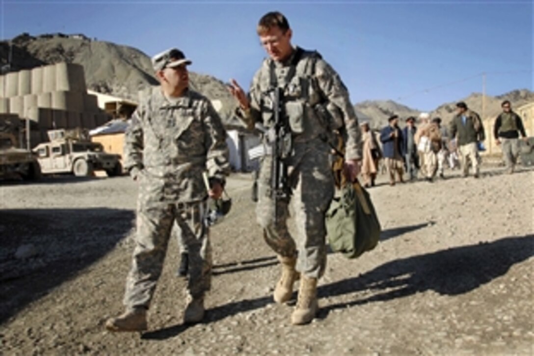 U.S. Air Force Lt. Col. Dan Moy, Paktia Provincial Reconstruction Team commander, right, talks with Army Master Sgt. Michael Barrows, a civil affairs team chief. The team took the provincial governor and other officials to meet at the remote combat outpost “Wilderness” in Paktia province, Afghanistan, Feb. 11, 2009.  