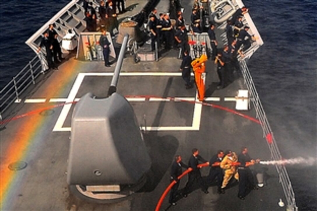 U.S. Navy sailors aboard the guided-missile cruiser USS Lake Champlain test the ship's fire hoses during a training exercise in the Pacific Ocean, Feb. 13, 2009.