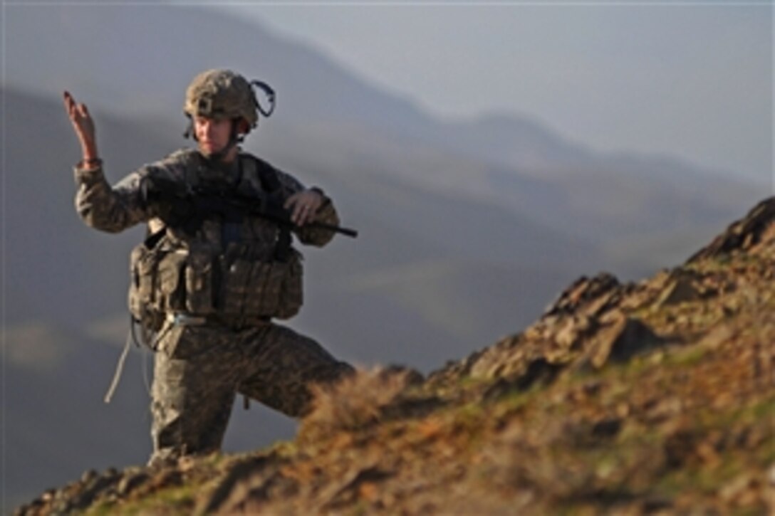 U.S. Army Spc. Curtis Widel gives a hand signal to his team during a dismount patrol near Forward Operating Base Lane in Zabul Province, Afghanistan, Feb. 26, 2009. Widel is assigned to Company B, 1st Battalion, 4th Infantry Regiment.