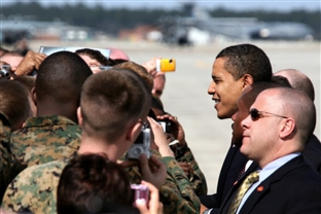 President Barack Obama greets some of the 200 Marines assigned to Marine Corps Air Station Cherry Point, N.C., and the 2nd Marine Aircraft Wing during part of his brief visit, Feb. 27, 2009. Obama and his staff stopped aboard the air station to transfer from Air Force One to take helicopters to Camp Lejeune, N.C.
 