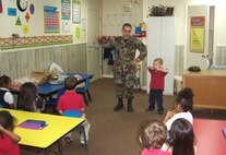 FORT WALTON BEACH, Fla. –  As his son, David,  watches, Tech. Sgt. Jefferson Sweet, a 919th Maintenance Squadron flight controls craftsman, uses a C-130 model to tell pre-schoolers at Calvary Christian Preschool about the Air Force Reserve’s  airplanes and his job at nearby Duke Field.  During the class’s show- and-tell portion, Sergeant Sweet shared with the children how he works on gauges and instruments on board Duke Field’s MC-130E Combat Talon I aircraft.   The young group asked questions like how much fuel is used and how the engines work.  (Courtesy photo)