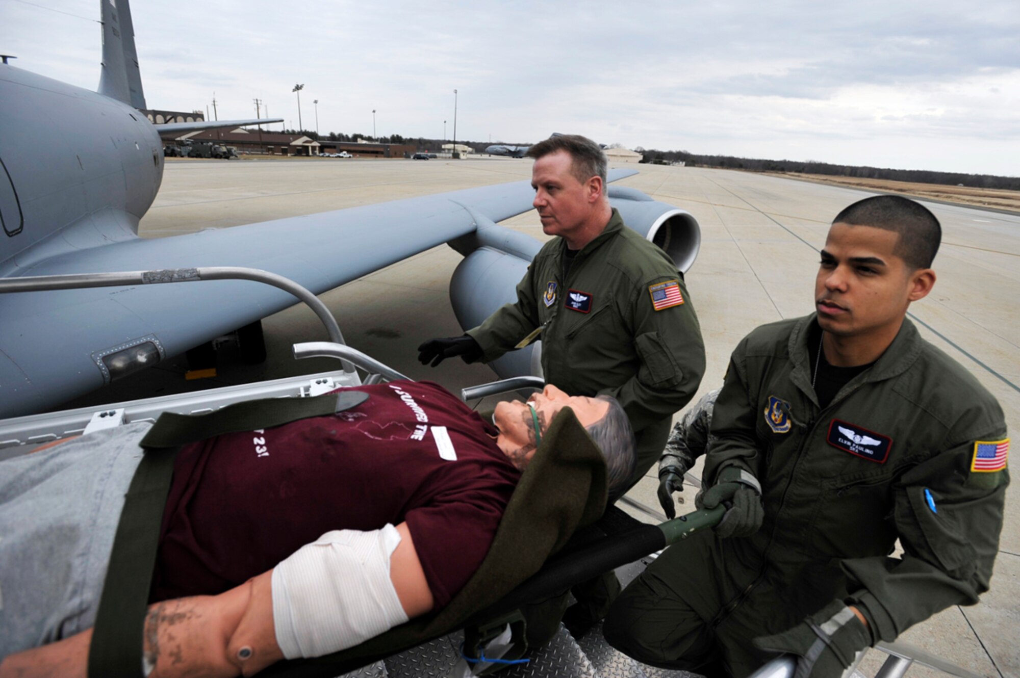 Master Sgt. John Kley (left) and Senior Airman Elivin Paulino help load a mock patient aboard a KC-135 Stratotanker at McGuire Air Force Base, N.J. A KC-135 crew from the 931st Air Refueling Group at McConnell Air Force Base, Kan., picked up medical Reservists assigned to McGuire mid-day Friday at the start of three-day aeromedical evacuation training mission. Sergeant Kley and Airman Paulino are assigned to the 514th Aeromedical Evacuation Squadron at McGuire AFB. (U.S. Air Force photo/Tech. Sgt. Jason Schaap