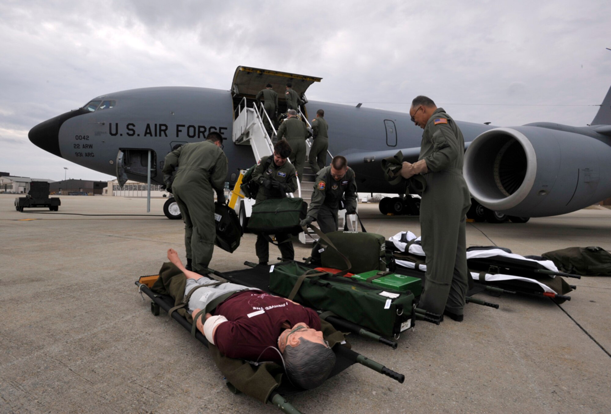 Reservists from the 514th Aeromedical Evacuation Squadron at McGuire Air Force Base, N.J., load training equipment on to a KC-135 Stratotanker Friday. Reservists from the 931st Air Refueling Squadron at McConnell Air Force Base, Kan., flew the KC-135 to McGuire AFB to begin a three-day aeromedical evacuation training mission. (U.S. Air Force photo/Tech. Sgt. Jason Schaap)