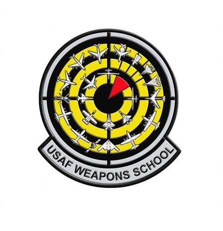 The new Weapons School’s patchdesign , adopted April 2008, reflects the expansion of the school, with 22 aircraft and weapons systems encircling a red “bomb on target” over a black and yellow bullseye background.  