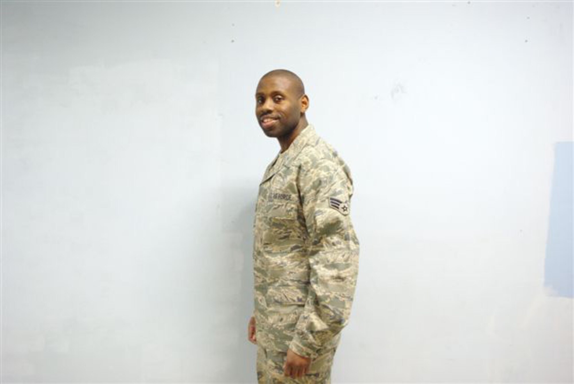 Senior Airman Jarvis Johnson, assigned to the Expeditionary Logistics Readiness Squadron at Manas Air Base, Kyrgyz Republic, shows off the new him. Airman Johnson arrived at Manas weighing 295 pounds, but had already decided to make some changes during his six month deployment. During his time at Manas, Airman Johnson lost 125 pounds and took 14 inches of his waist. (Courtesy photo)