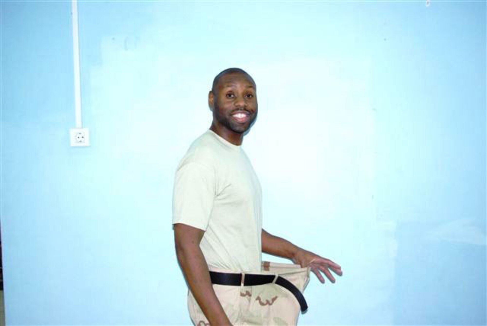 Senior Airman Jarvis Johnson, assigned to the Expeditionary Logistics Readiness Squadron at Manas Air Base, Kyrgyz Republic, shows off the new him. Airman Johnson arrived at Manas weighing 295 pounds, but had already decided to make some changes during his six month deployment. During his time at Manas, Airman Johnson lost 125 pounds and took 14 inches of his waist. (Courtesy photo)