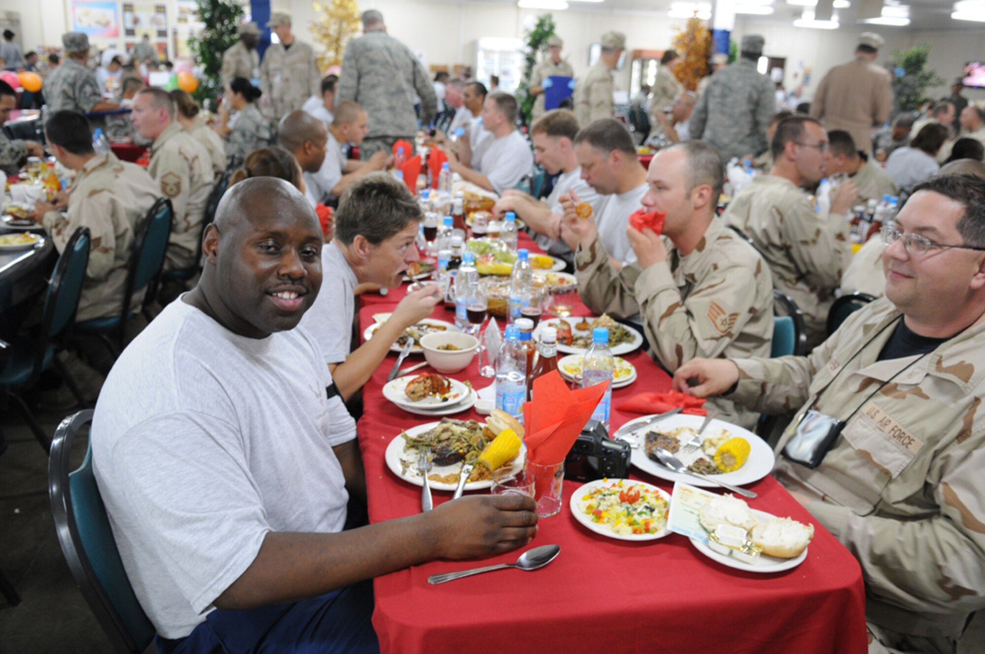 Senior Airman Jarvis Johnson, assigned to the Expeditionary Logistics Readiness Squadron at Manas Air Base, Kyrgyz Republic, sits down for dinner with some deployed friends. At the time, Airman Johnson weighed 295 pounds, but had already decided to make some changes during his six month deployment. During his time at Manas, Airman Johnson lost 125 pounds and took 14 inches of his waist. (Courtesy photo)