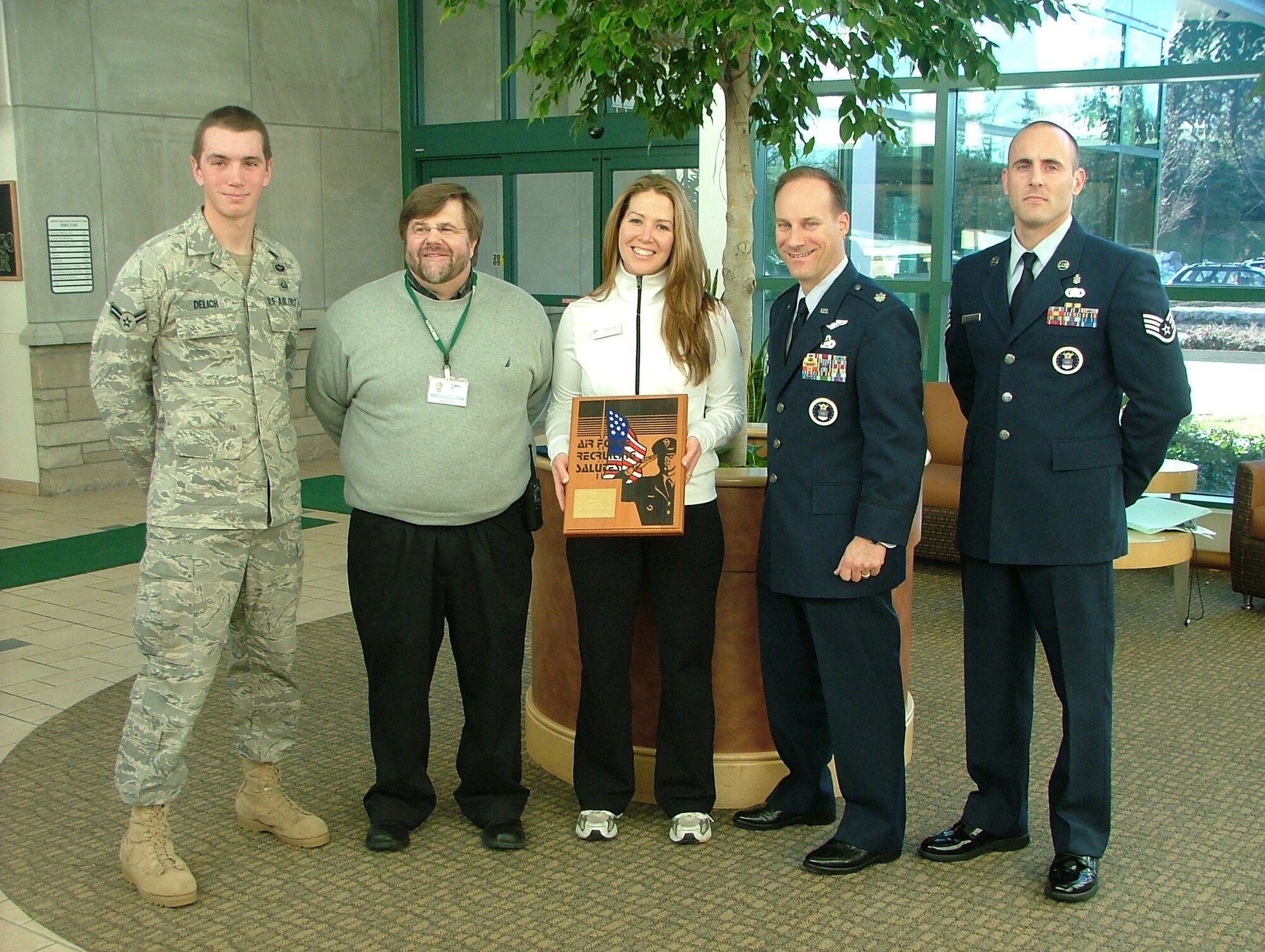 Lt. Col. Todd Weyerstrass, 339th Recruiting Squadron commander, presented the Air Force Recruiting Salutes Award to the Bronson Athletic Club Dec. 29, 2008 in Kalamazoo, Mich. Attending the award presentation were (from left to right) Michigan native and pararescue student Airman 1st Class Corey Delich, Bronson General Manager Jim Reading, Bronson personal trainer Rebekah Bolt, and Benton Harbor, Mich. recruiter, Staff Sgt. Ryan Ballard. (U.S. Air Force photo/Master Sgt. Michael McMillen)  